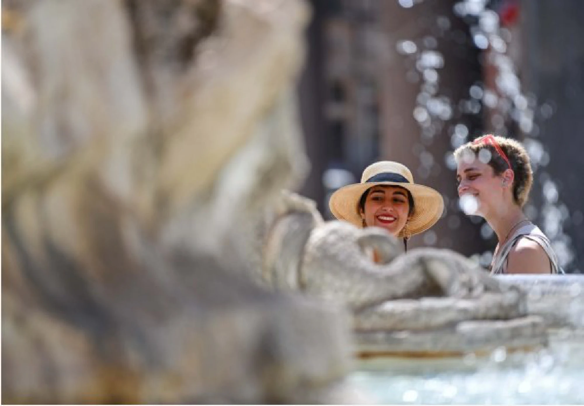  Tourists cool off near a fountain in Rome, Italy, Aug. 12, 2021.