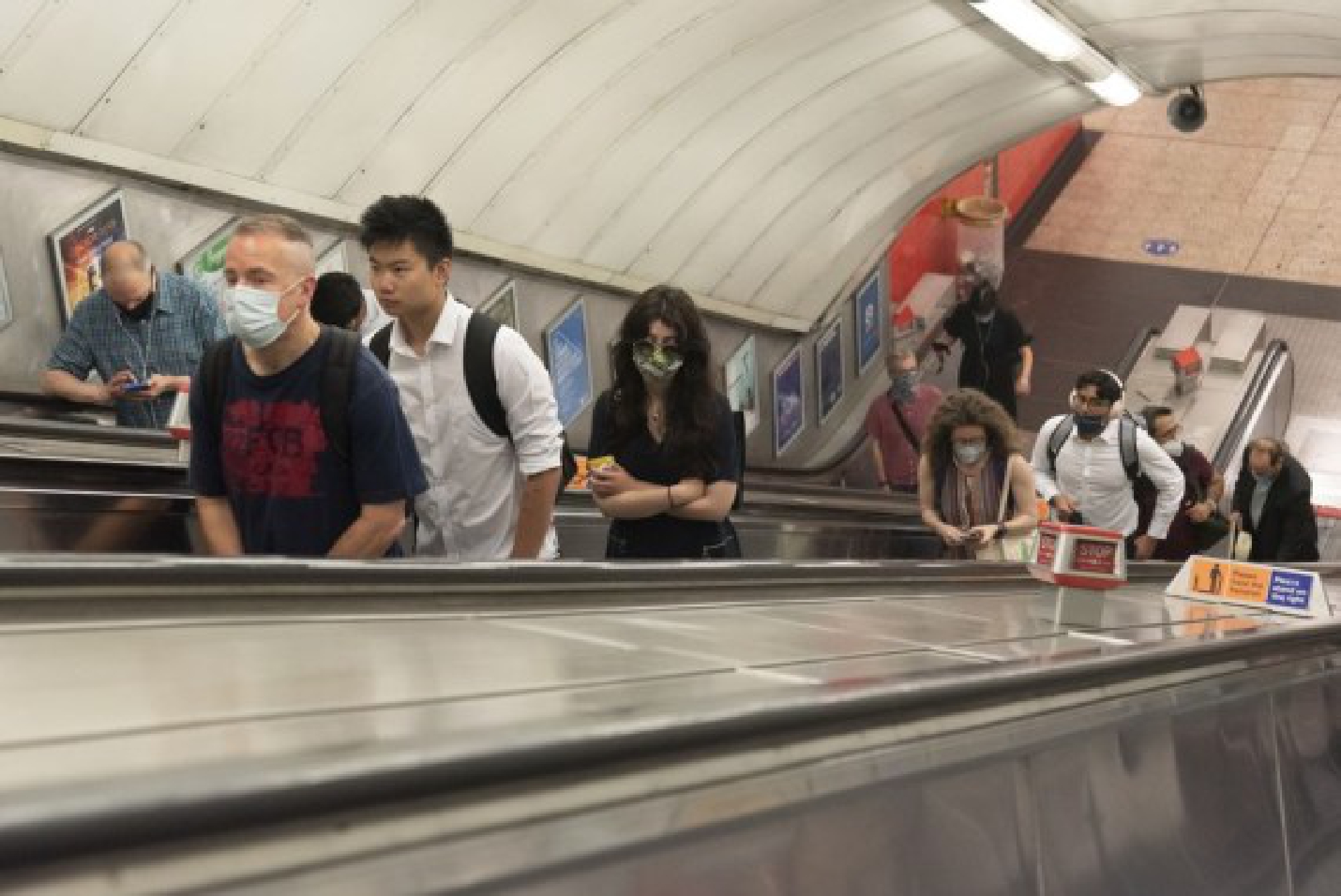 Passengers walk in an underground station during the morning rush hour in London, Britain, on July 19, 2021.