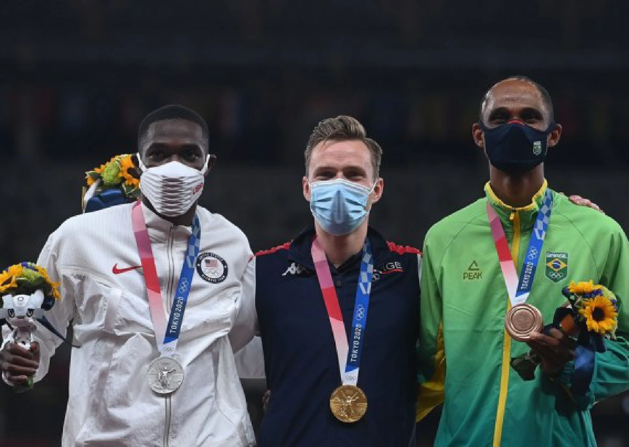 (From L to R) Silver medalist Rai Benjamin of the United States, gold medalist Karsten Warholm of Norway and bronze medalist Alison dos Santos of Brazil pose for a photo on the awarding ceremony of the men's 400m hurdles at the Tokyo 2020 Olympic Games in Tokyo, Japan, Aug. 3, 2021.