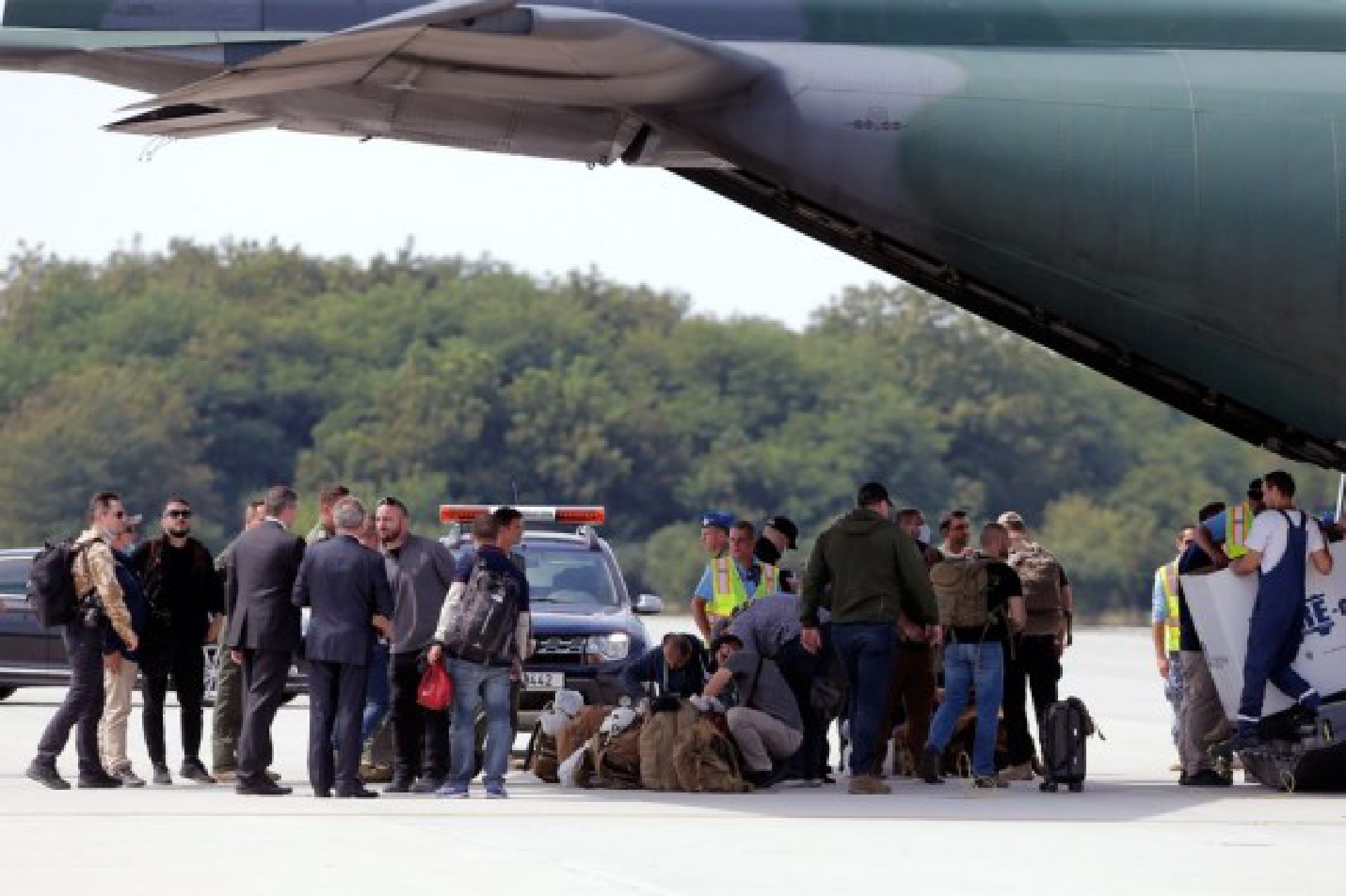 Romanians and Bulgarians evacuated from Afghanistan are seen on the tarmac after landing with a C-130 Hercules aircraft near Bucharest, Romania, on Aug. 21, 2021. The Romanian military plane returned here on Saturday from Kabul, the capital of Afghanistan, bringing back 15 Romanian nationals and four Bulgarian citizens.