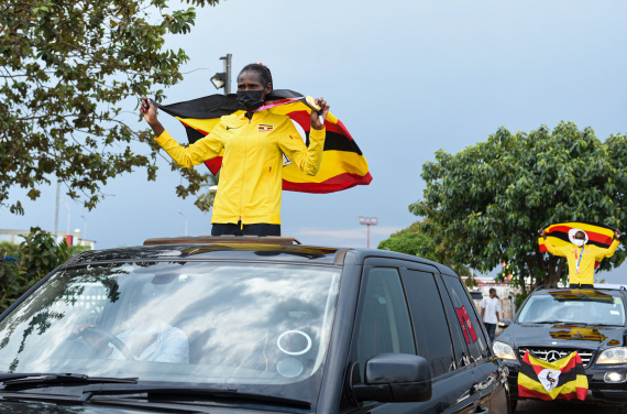 Peruth Chemutai (L), who won gold in the women's 10,000m final at Tokyo Olympics, and Jacob Kiplimo who took bronze in the men's 10,000m final, leave Entebbe International Airport, Uganda, Aug. 10, 2021.