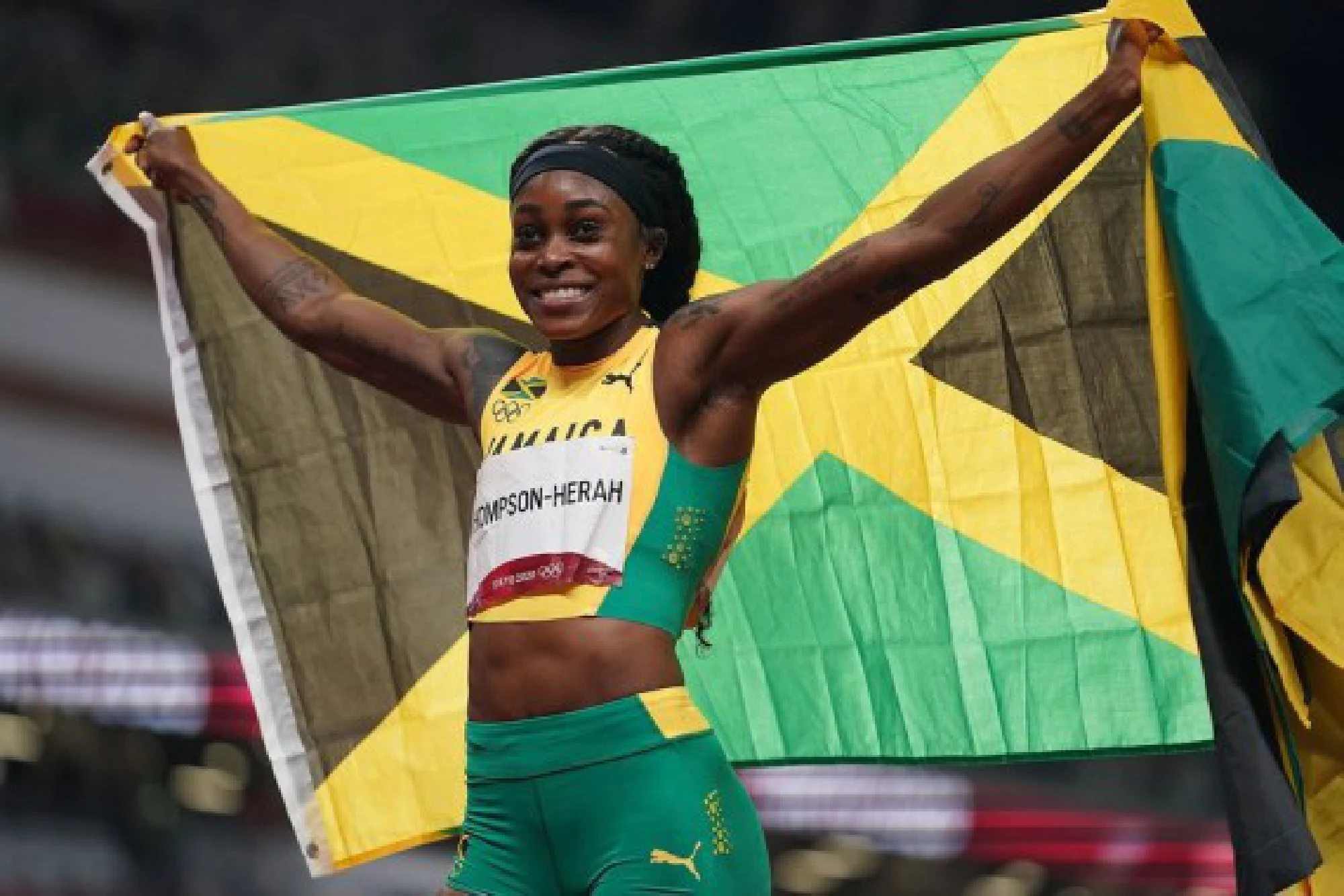 Elaine Thompson-Herah of Jamaica celebrates after winning the women's 200m final at Tokyo 2020 Olympic Games, Aug. 3, 2021. 