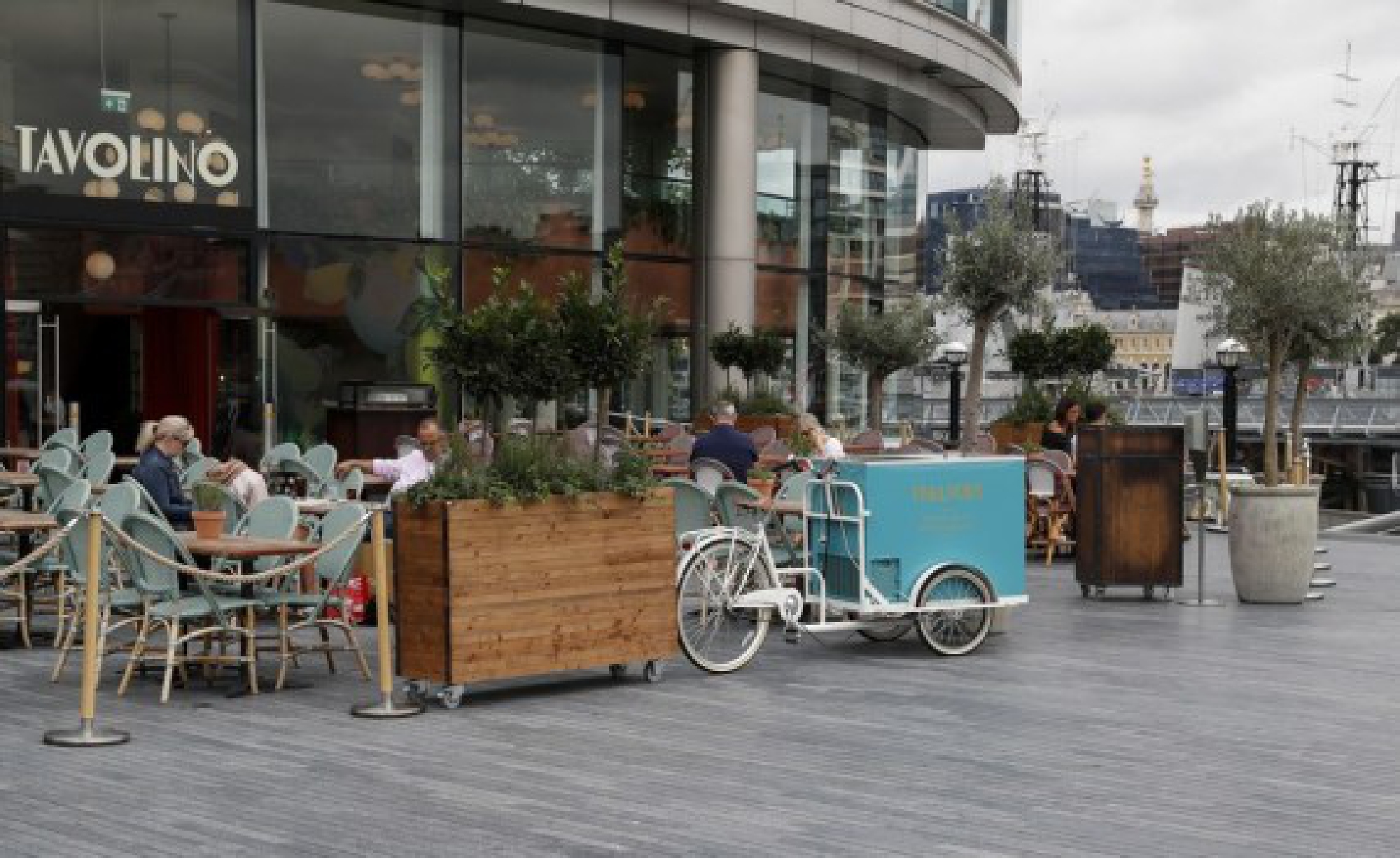 People dine in the outdoor dining area of a restaurant in London, Britain, on Aug. 13, 2021.