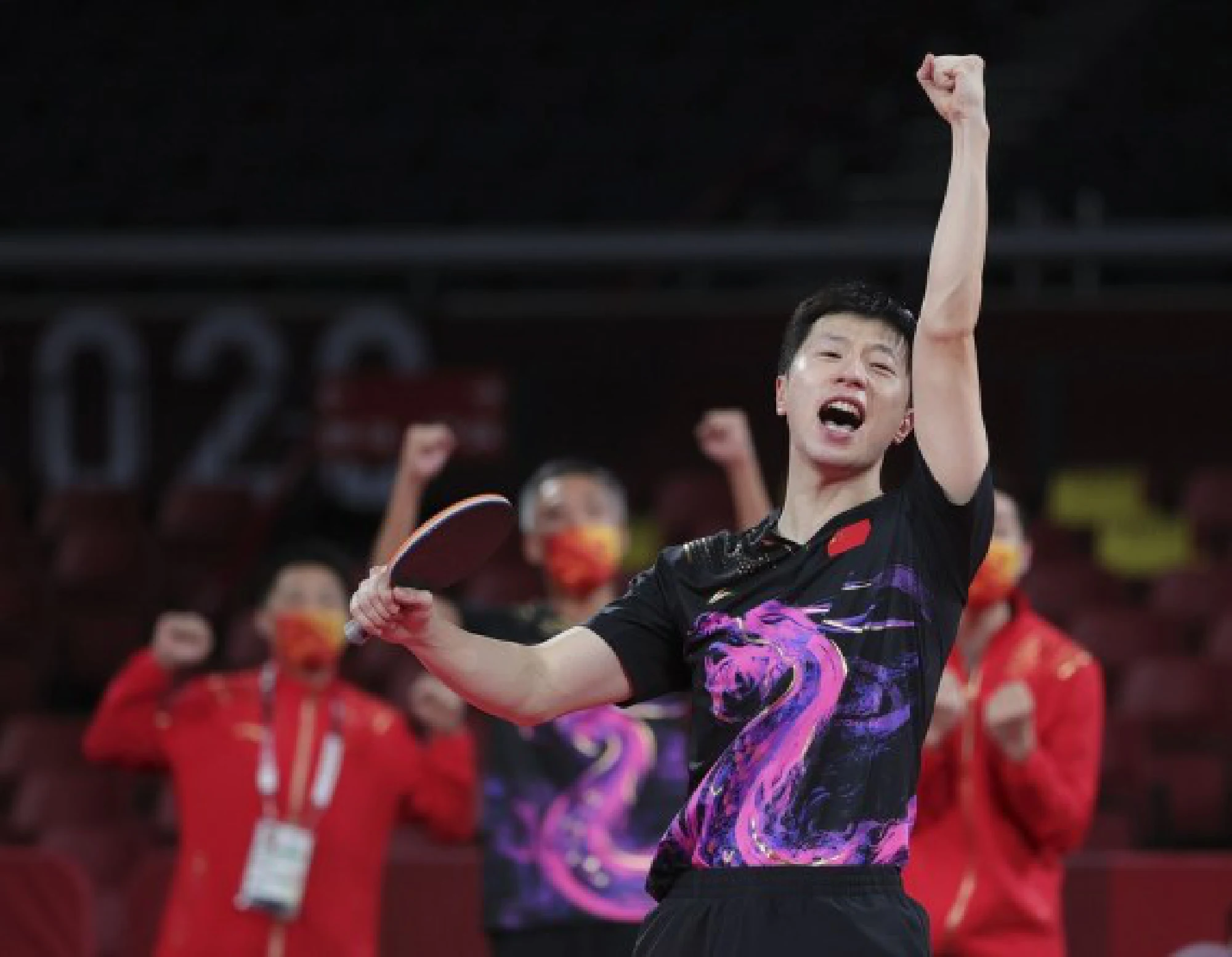 Ma Long of China celebrates after beating Timo Boll of Germany during the table tennis men's team final between China and Germany at the Tokyo 2020 Olympic Games in Tokyo, Japan, Aug. 6, 2021. 