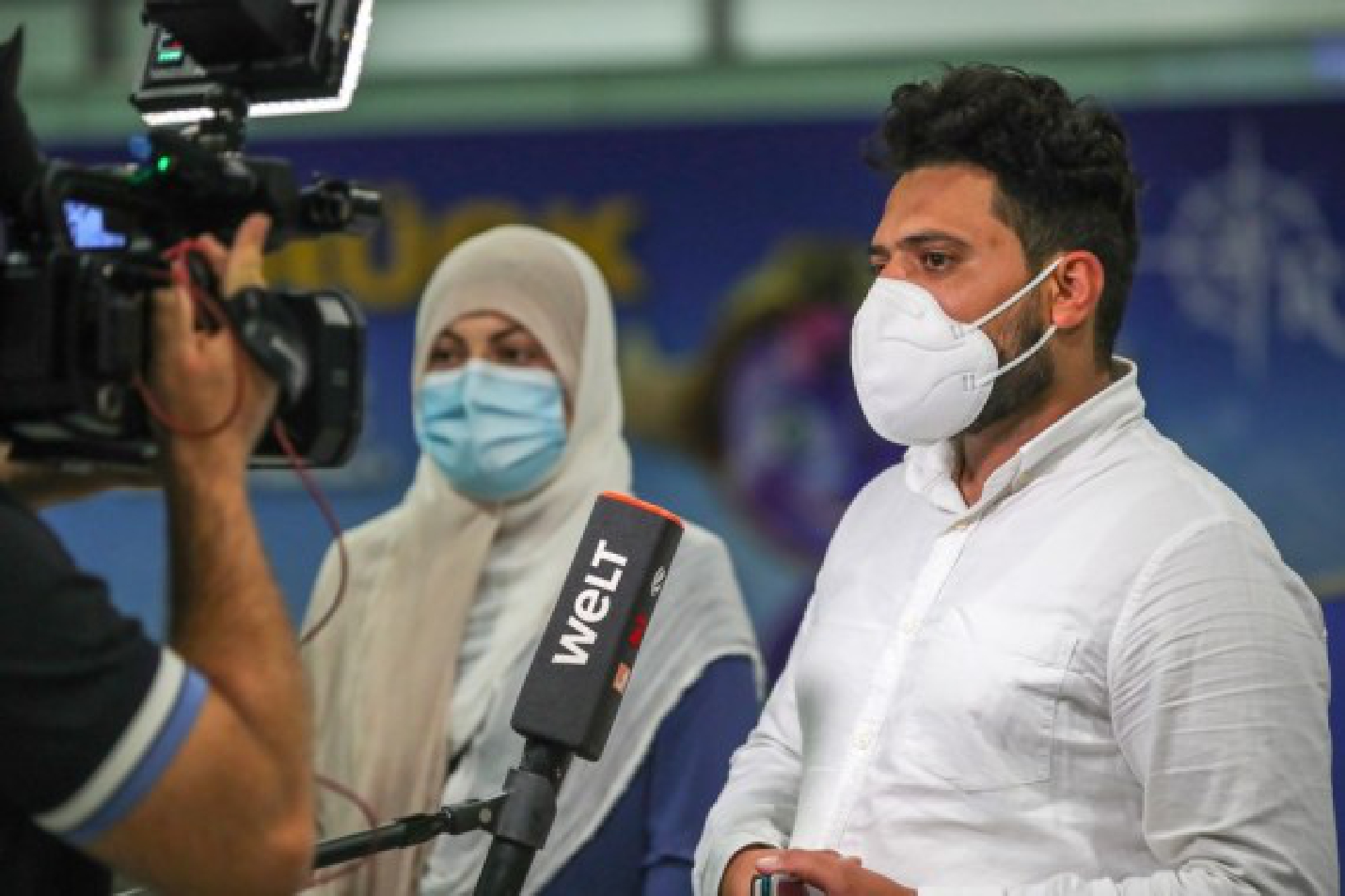 A couple who is evacuated from Afghanistan by a flight of Lufthansa is interviewed upon their arrival at Frankfurt International Airport, in Frankfurt, Germany, Aug. 20, 2021. 