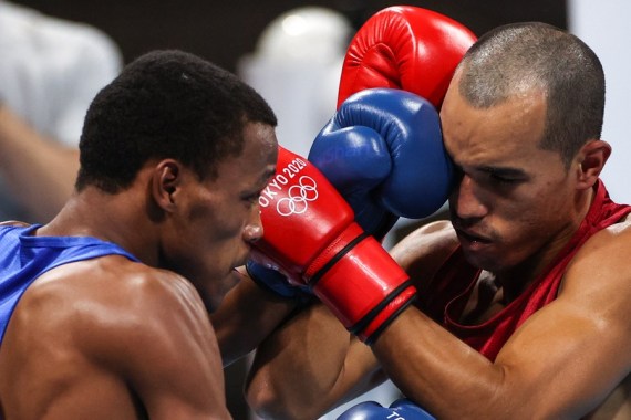 Eldric Sella Rodriguez (R) of the Refugee Olympic Team (EOR) competes with Dominica's Euri Cedeno Martinez during the men's middle (69-75kg) preliminary match of boxing at the Tokyo 2020 Olympic Games in Tokyo, Japan, July 26, 2021.