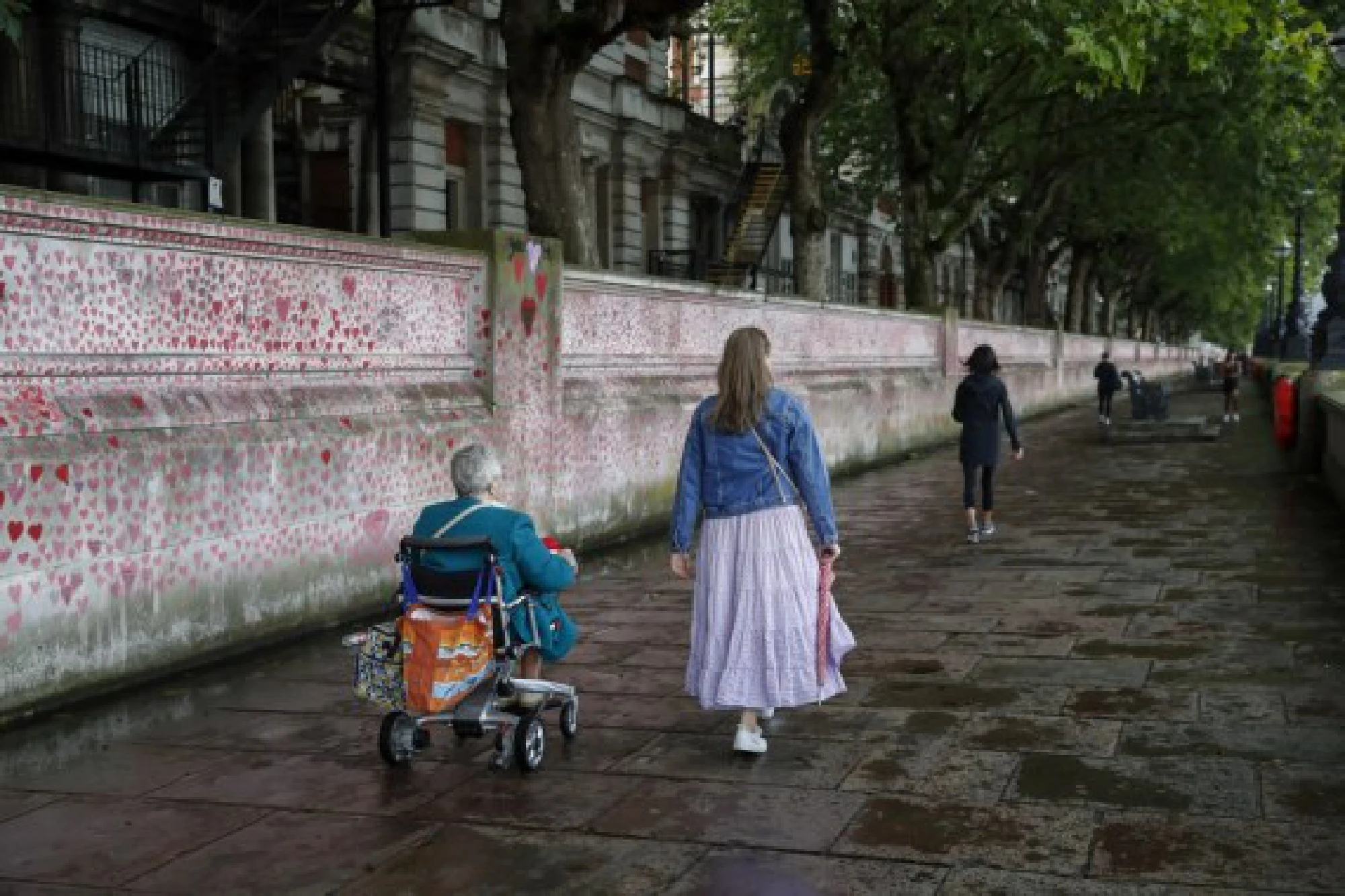 People walk past the National COVID Memorial Wall in London, Britain, Aug. 9, 2021.