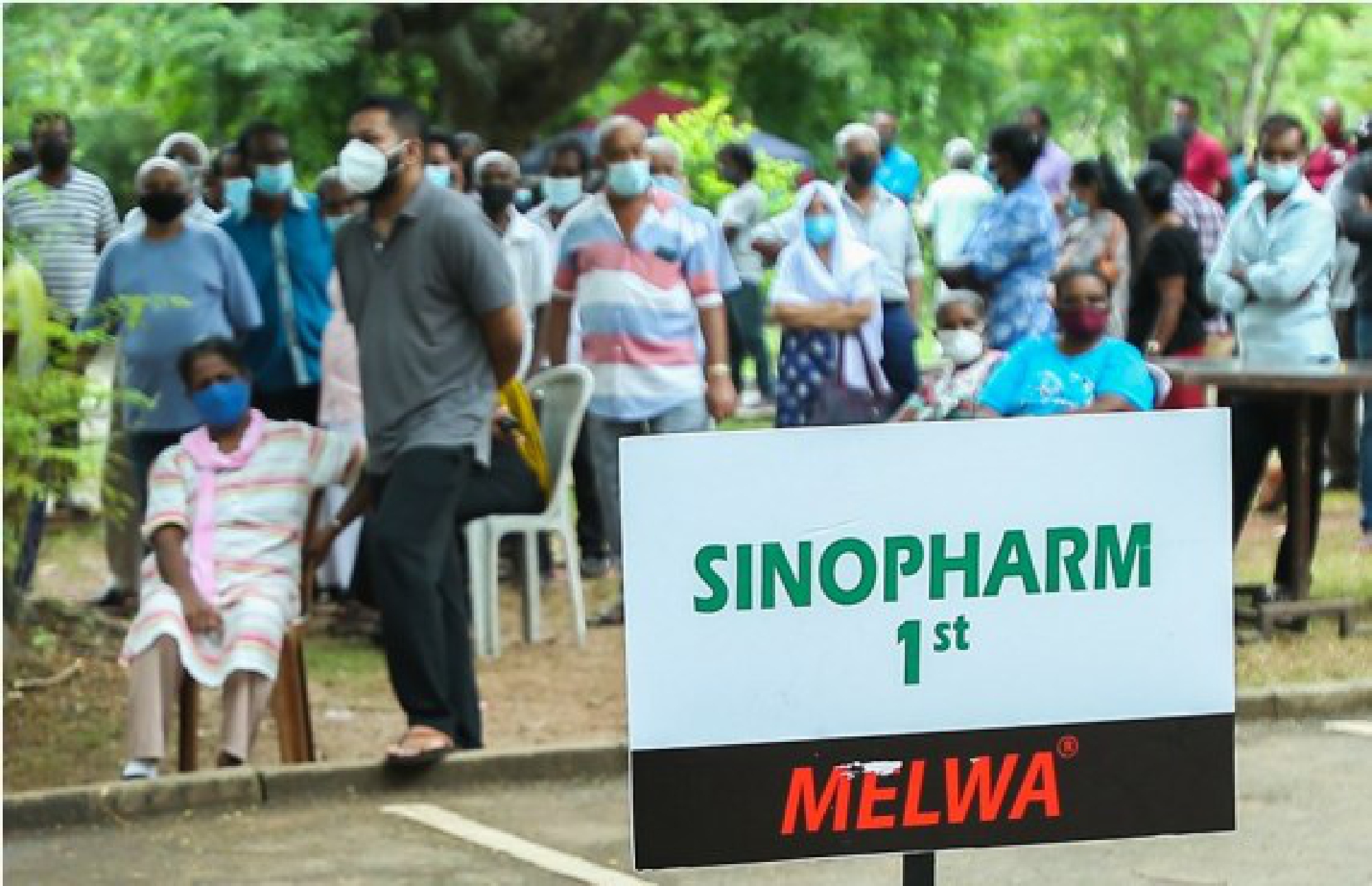 People wait to receive the Sinopharm COVID-19 vaccine in Colombo, Sri Lanka, on Aug. 7, 2021. 