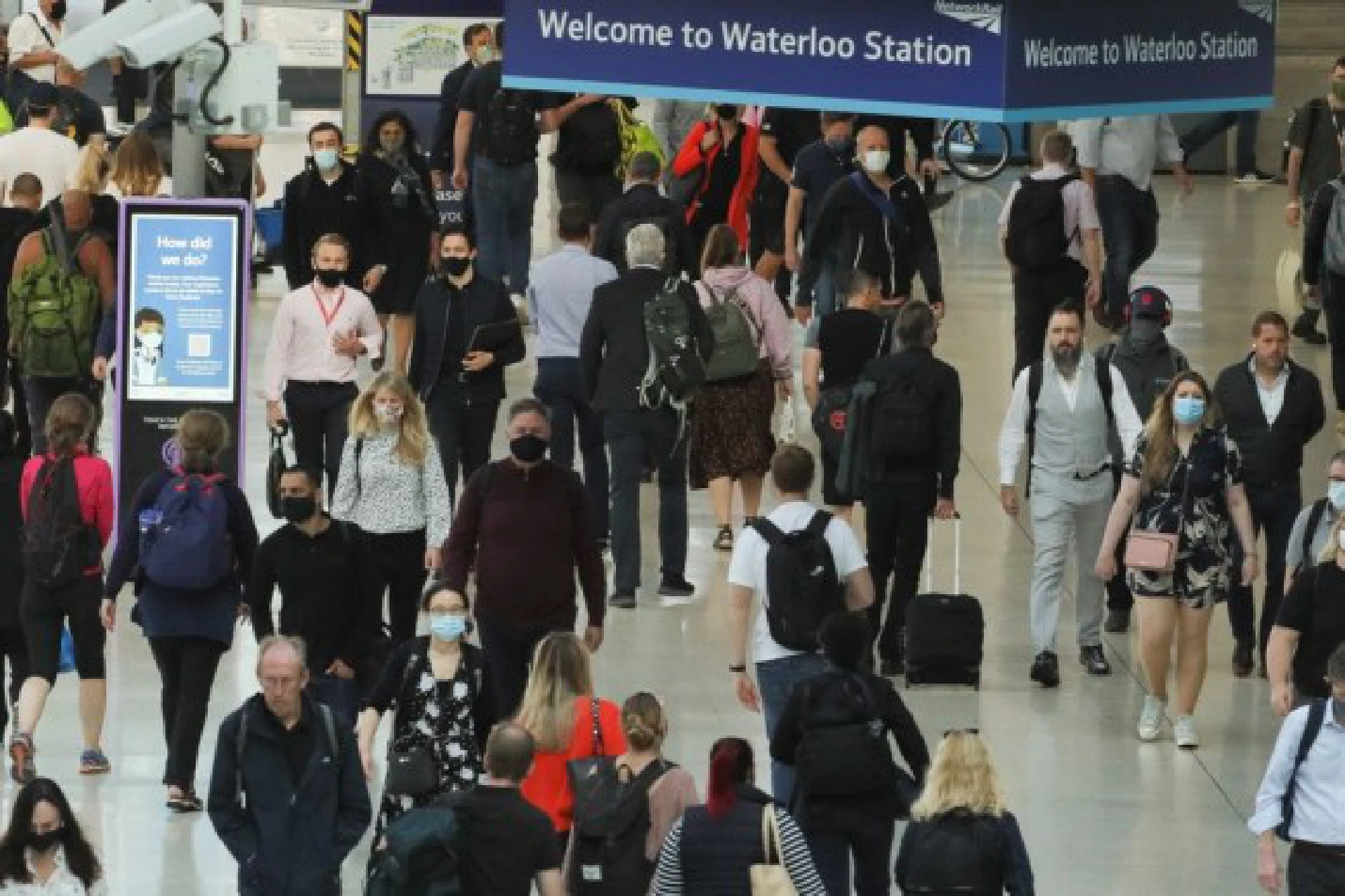 Passengers walk at Waterloo train station in London, Britain, on Aug. 5, 2021. 