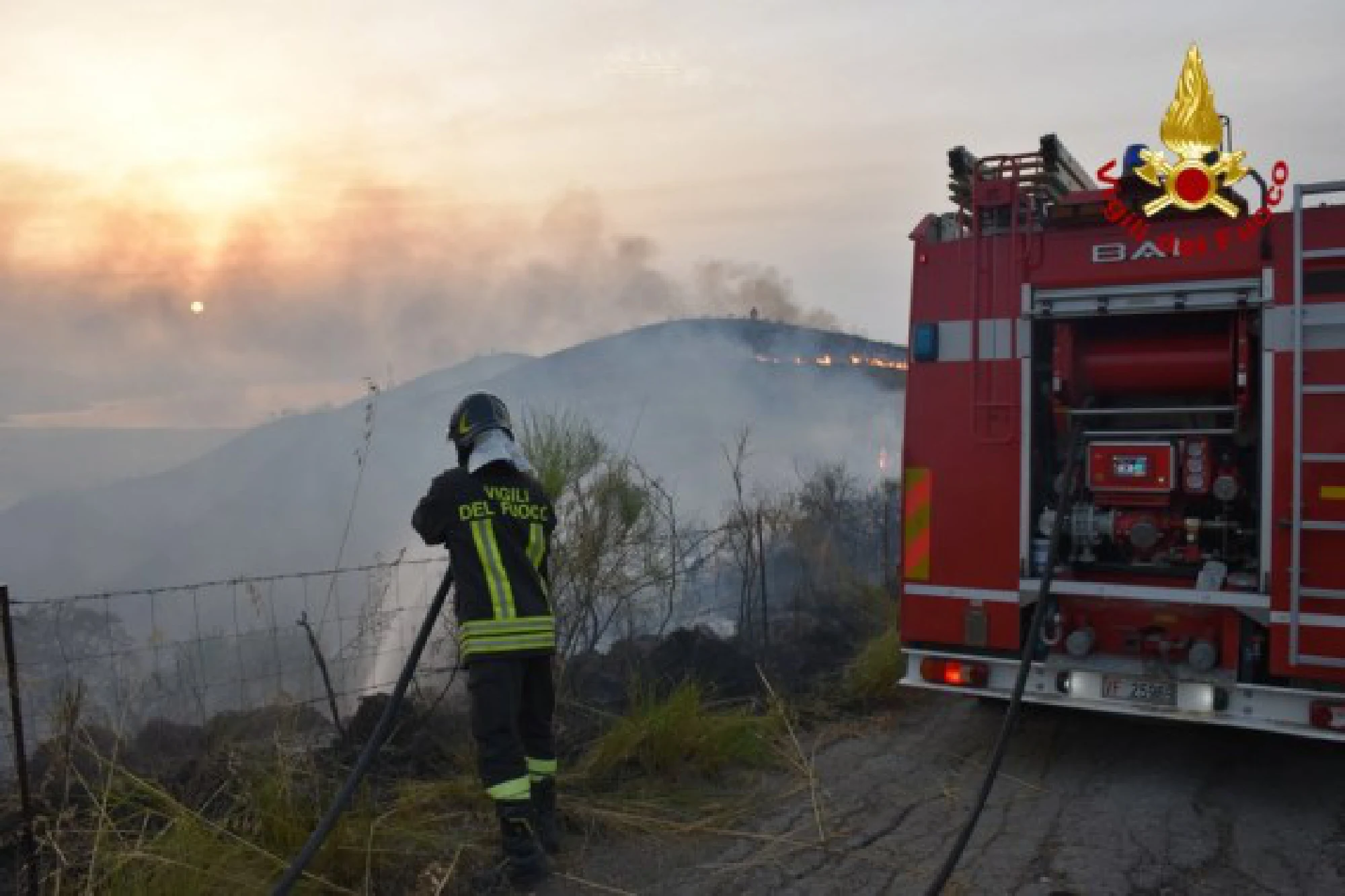 A firefighter battles against wildfires on Sicily Island, Italy, Aug. 1, 2021. 