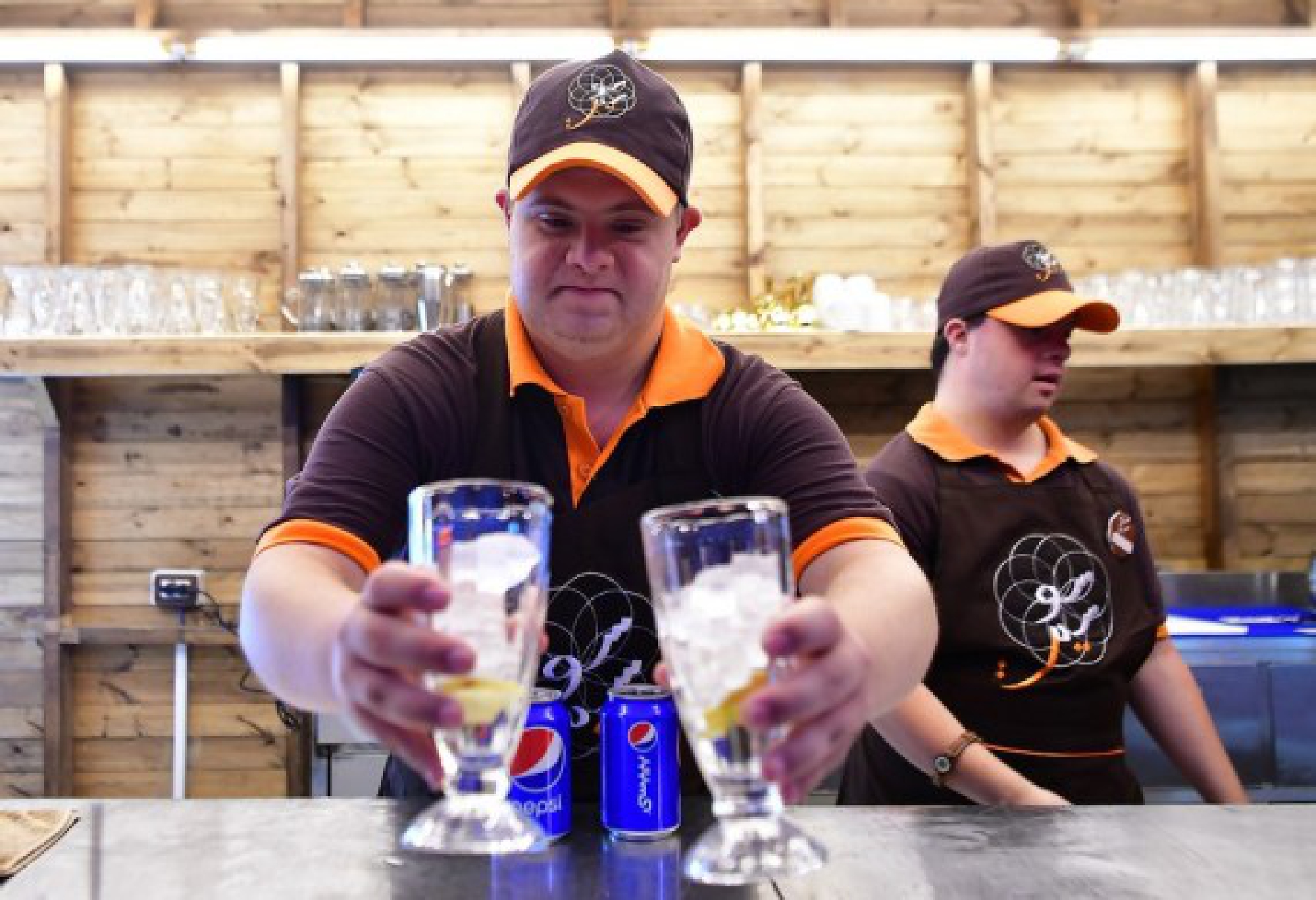 Young Syrians with Down Syndrome work at a cafe called Sucette in the capital Damascus on Aug. 21, 2021. 