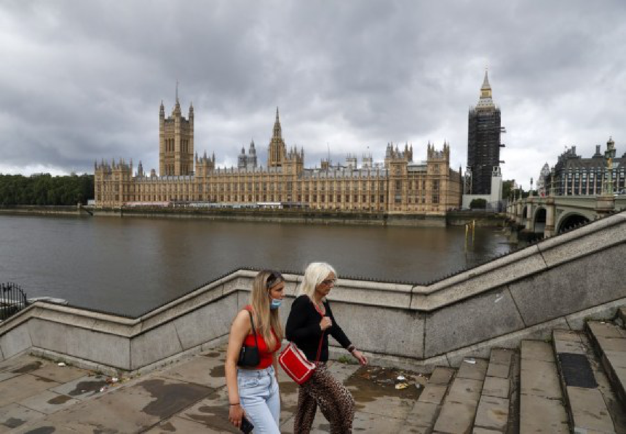 People walk past the Houses of Parliament in London, Britain, Aug. 9, 2021.