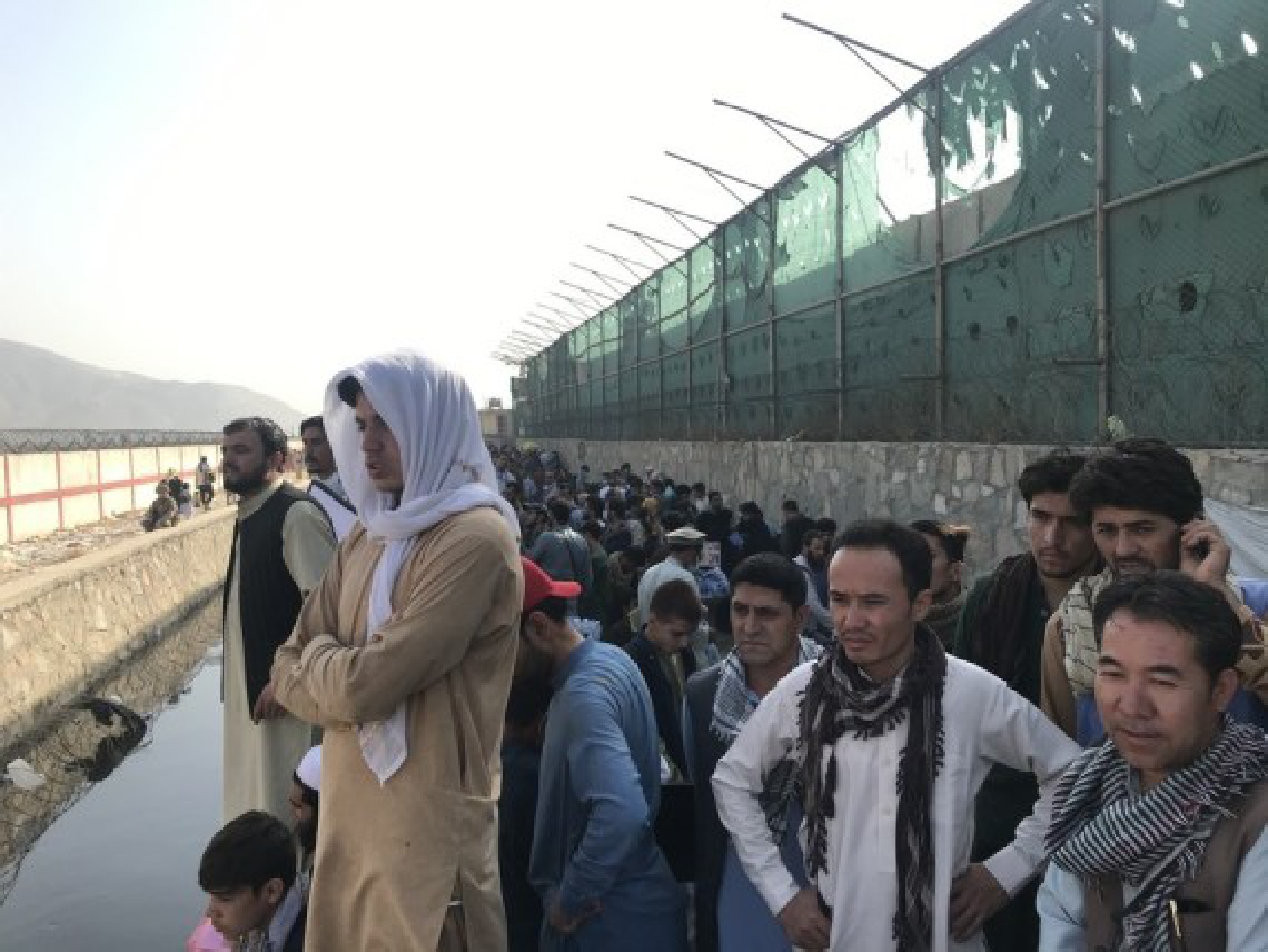 Afghans gather near a gate of Kabul airport in Kabul, Afghanistan, Aug. 22, 2021. 