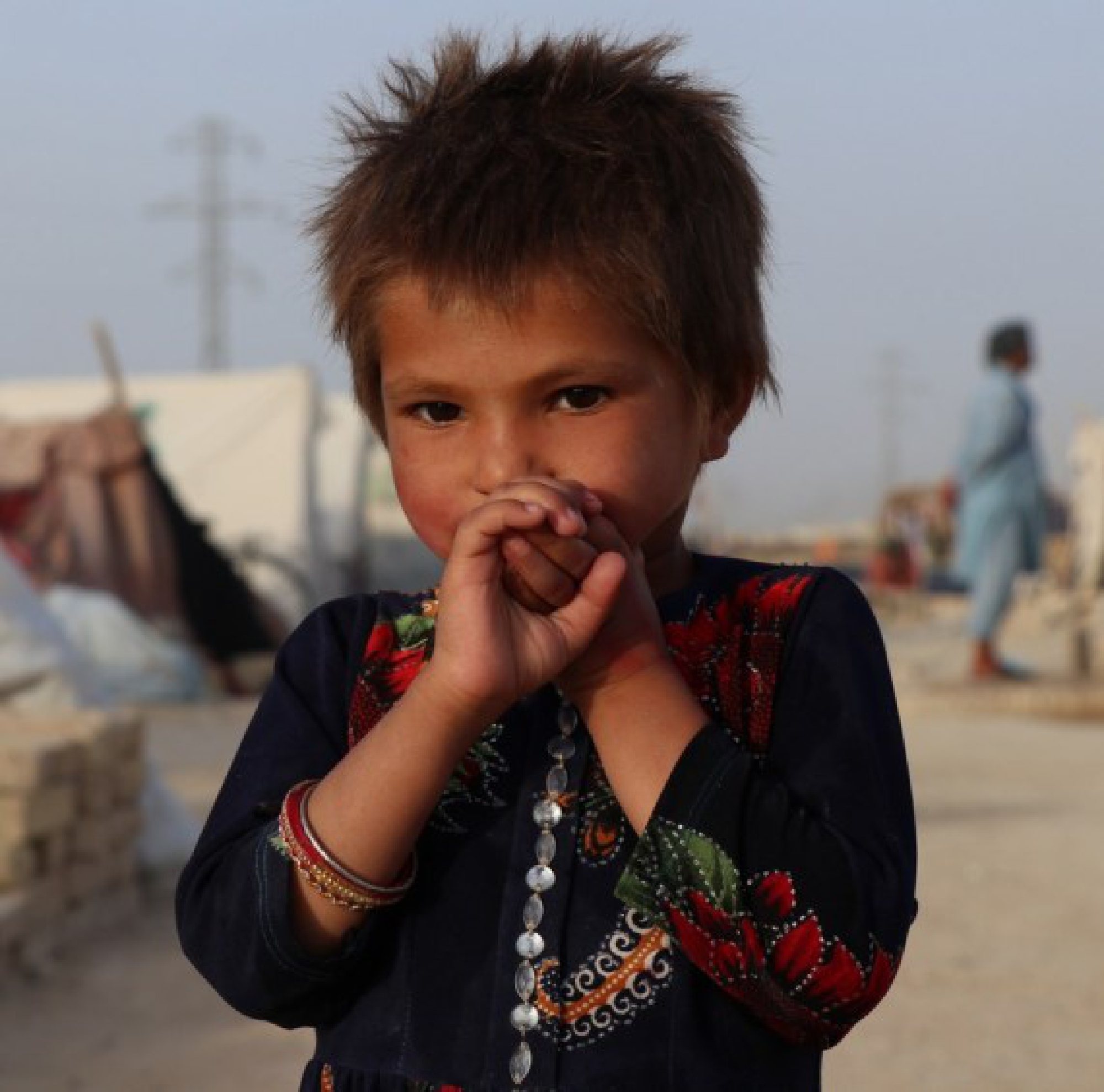 A displaced Afghan child is seen at a makeshift camp site in Mazar-i-Sharif, capital of Balkh province, Afghanistan, July 31, 2021. 