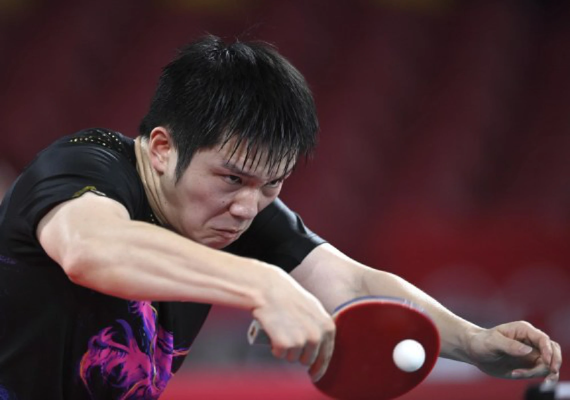 Fan Zhendong of China competes during the table tennis men's team gold medal match between China and Germany at the Tokyo 2020 Olympic Games in Tokyo, Japan, Aug. 6, 2021. 