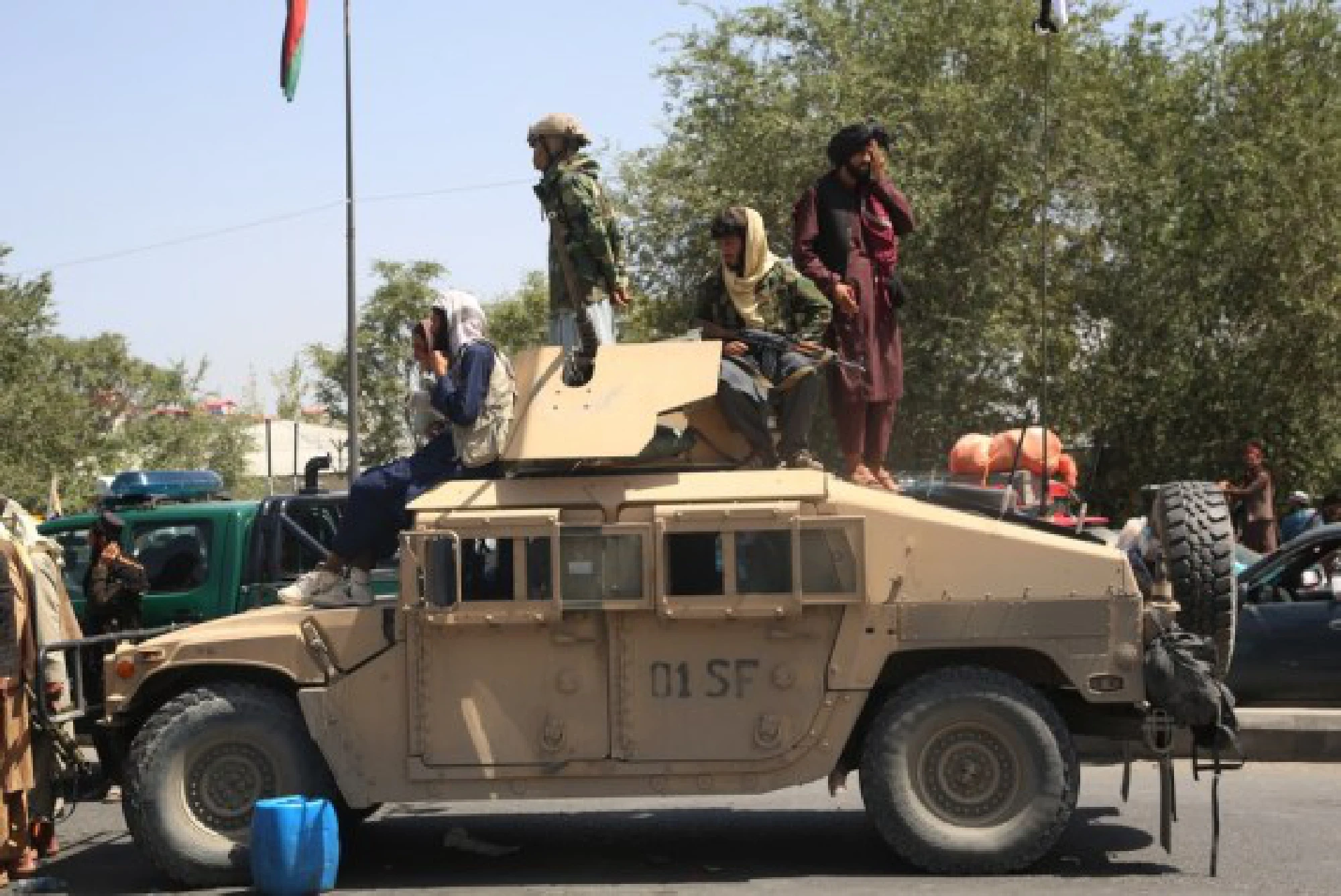 Afghan Taliban fighters are seen on a military vehicle in Kabul, capital of Afghanistan, Aug. 16, 2021.