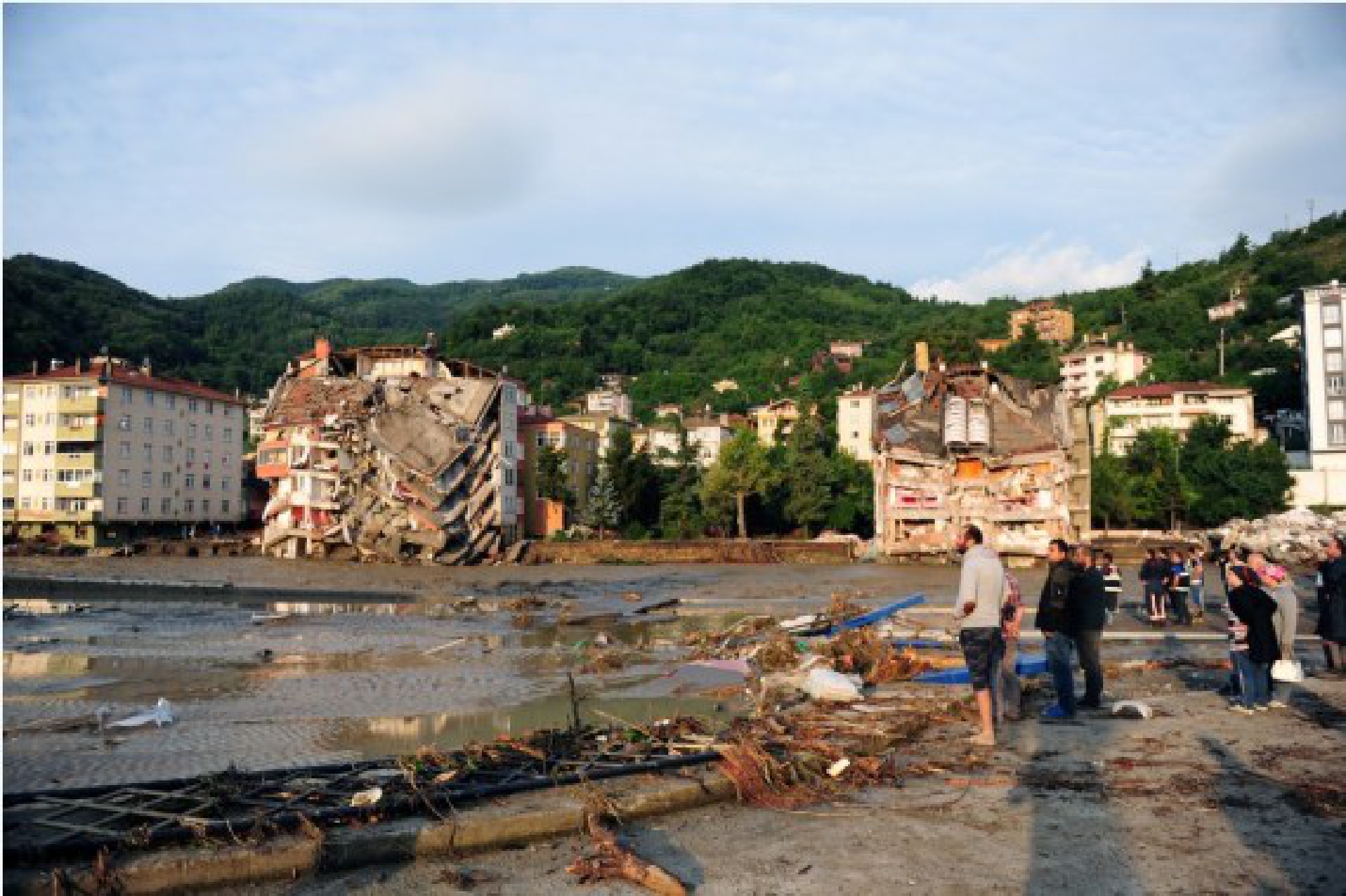 People are seen at a residential area affected by floods in Bozkurt district of Kastamonu province, Turkey, on Aug. 12, 2021.