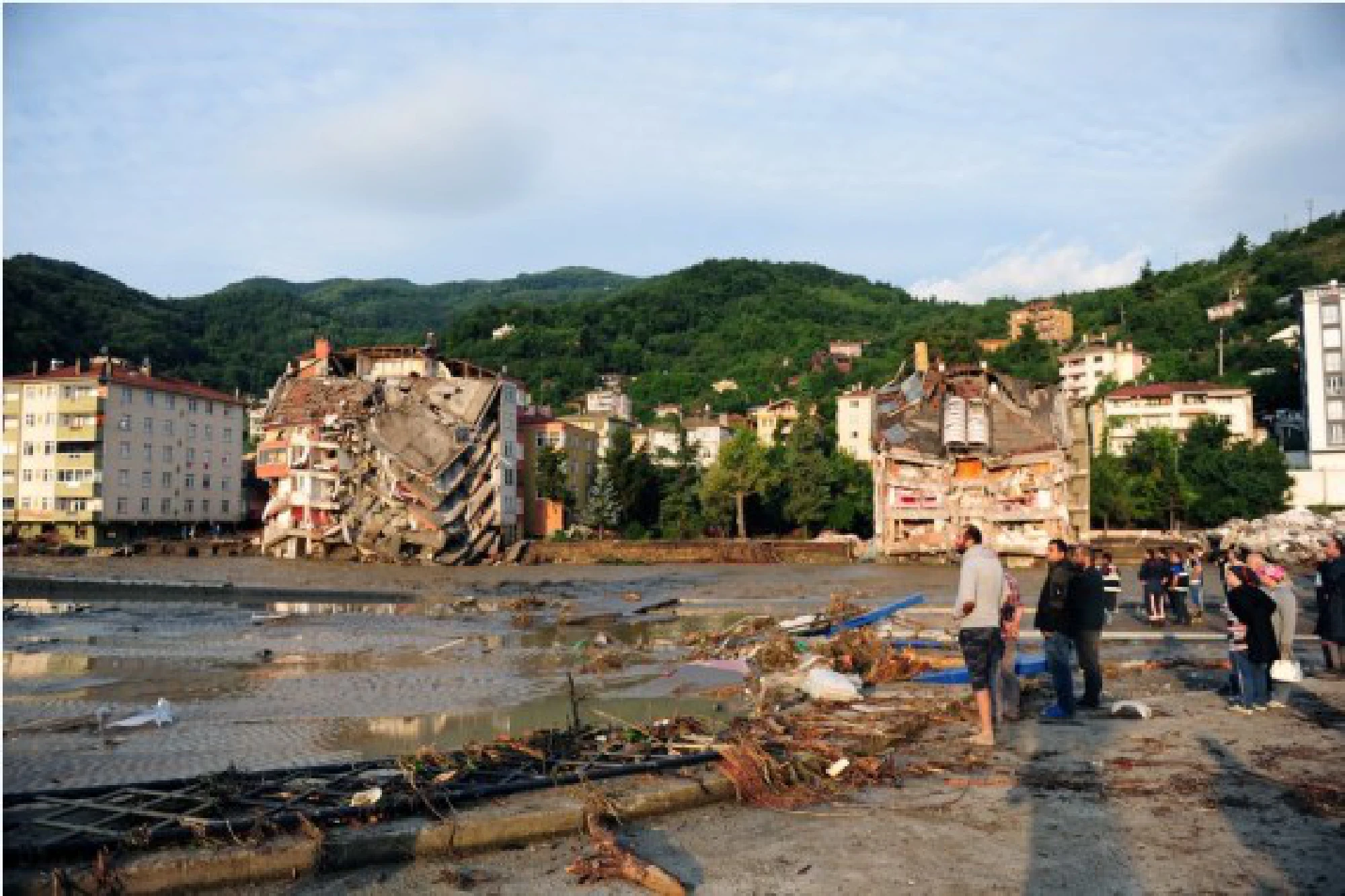 People are seen at a residential area affected by floods in Bozkurt district of Kastamonu province, Turkey, on Aug. 12, 2021.
