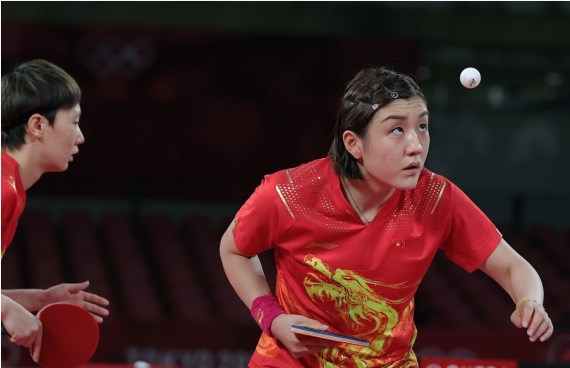 Chen Meng (R) and Wang Manyu of China compete during their table tennis women's team semifinal against Germany at the Tokyo 2020 Olympic Games in Tokyo, Japan, Aug. 4, 2021.