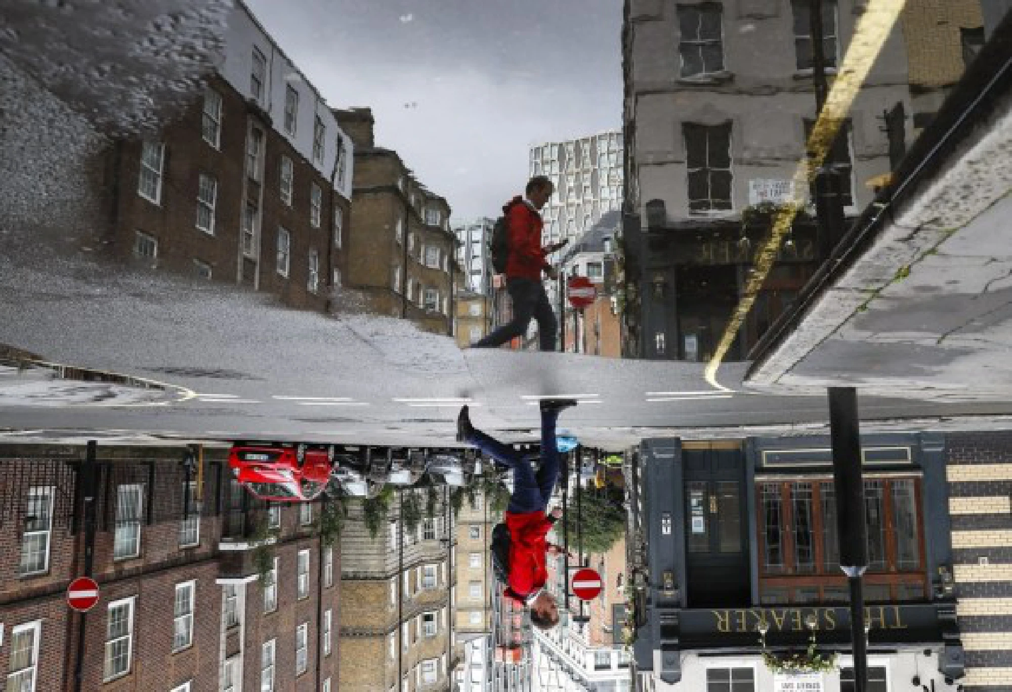 This reversed photo shows a man walking next to a puddle in London, Britain, Aug. 9, 2021.