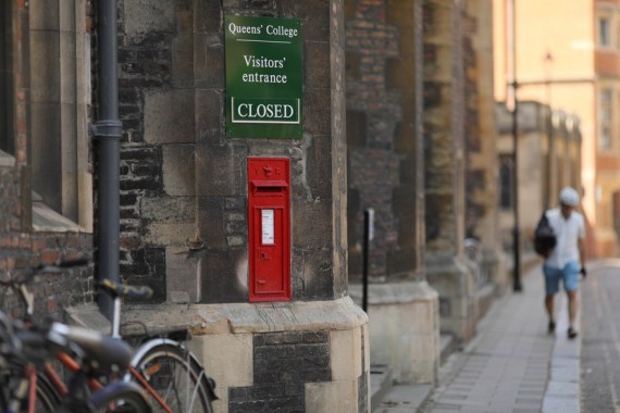Photo taken on May 22, 2020 shows a sign outside Queen's College, University of Cambridge, which is closed to visitors, in Cambridge, Britain.