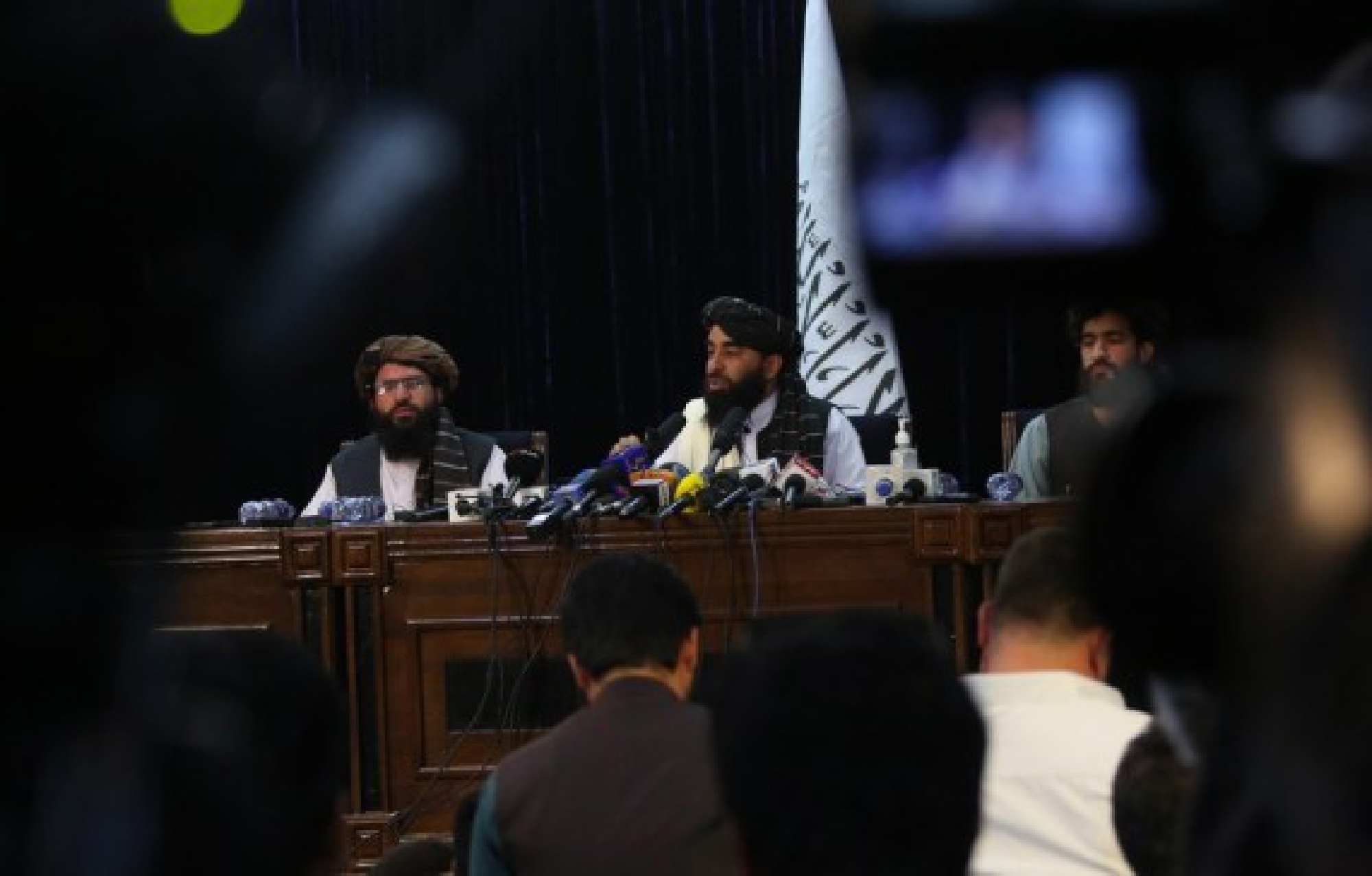 Taliban spokesman Zabihullah Mujahid (C, Rear) attends a press conference in Kabul, capital of Afghanistan, on Aug. 17, 2021. 