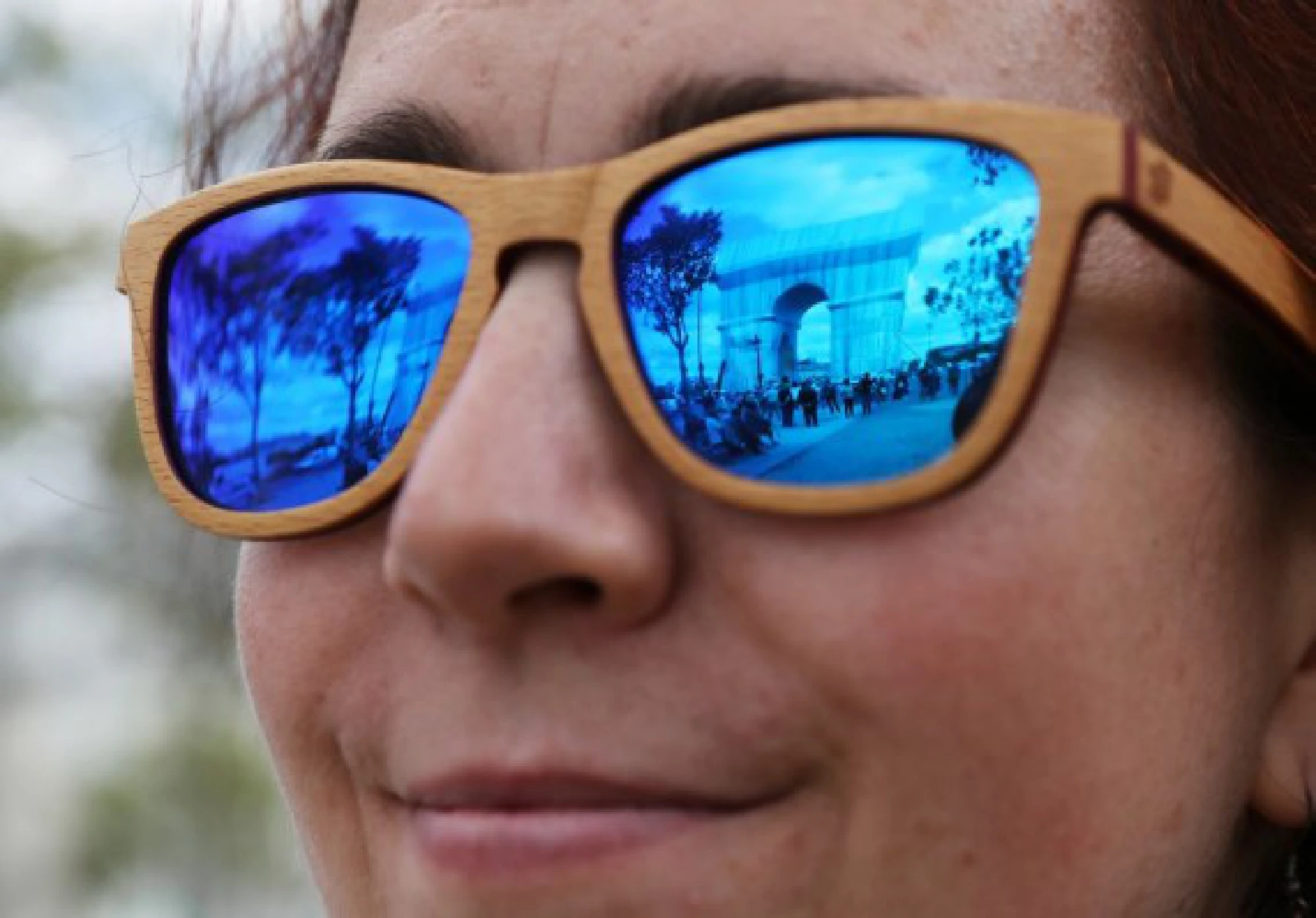 The wrapped Arc de Triomphe is seen reflected in a woman's sunglasses in Paris, France, on Sept. 16, 2021. (Xinhua/Gao Jing)