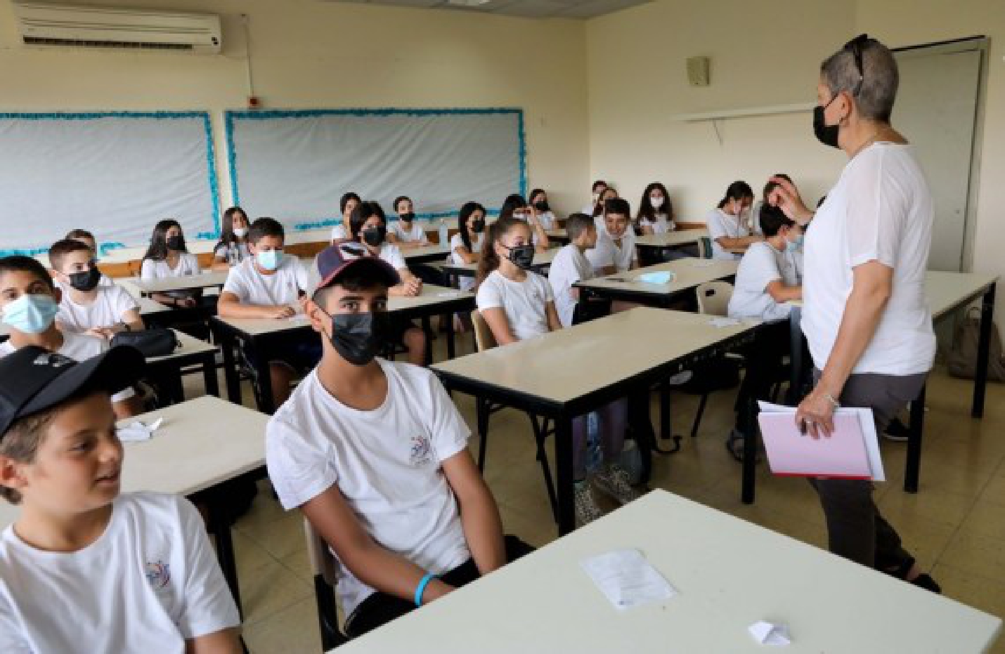 Israeli students wearing masks are seen in a classroom on the first day of new school year amid the COVID-19 pandemic, in the central Israeli city of Modiin, Sept. 1, 2021. 