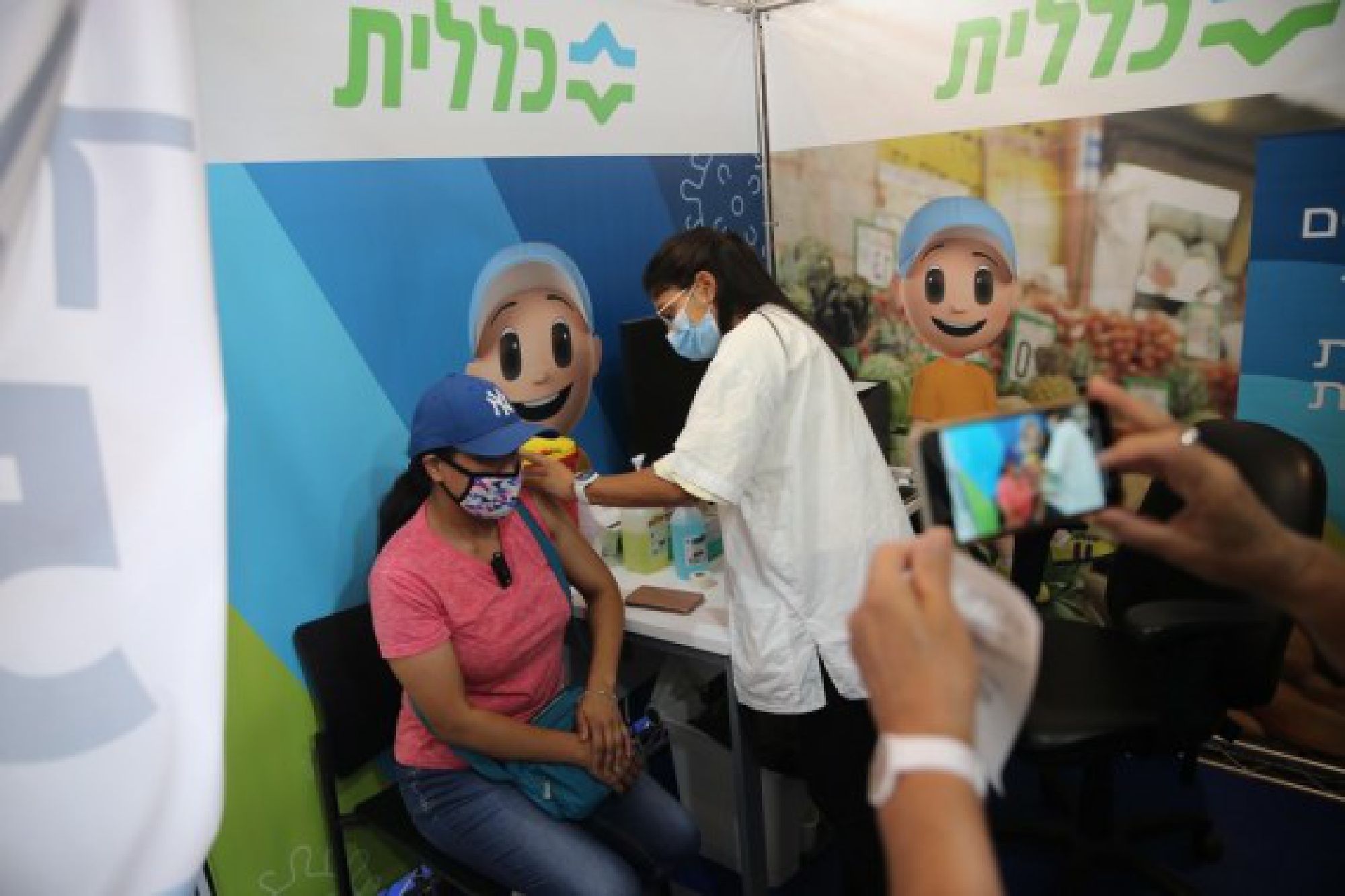 An Israeli woman receives her third dose of the COVID-19 vaccine at the Clalit Healthcare Maintenance Organization in Jerusalem, Aug. 24, 2021.