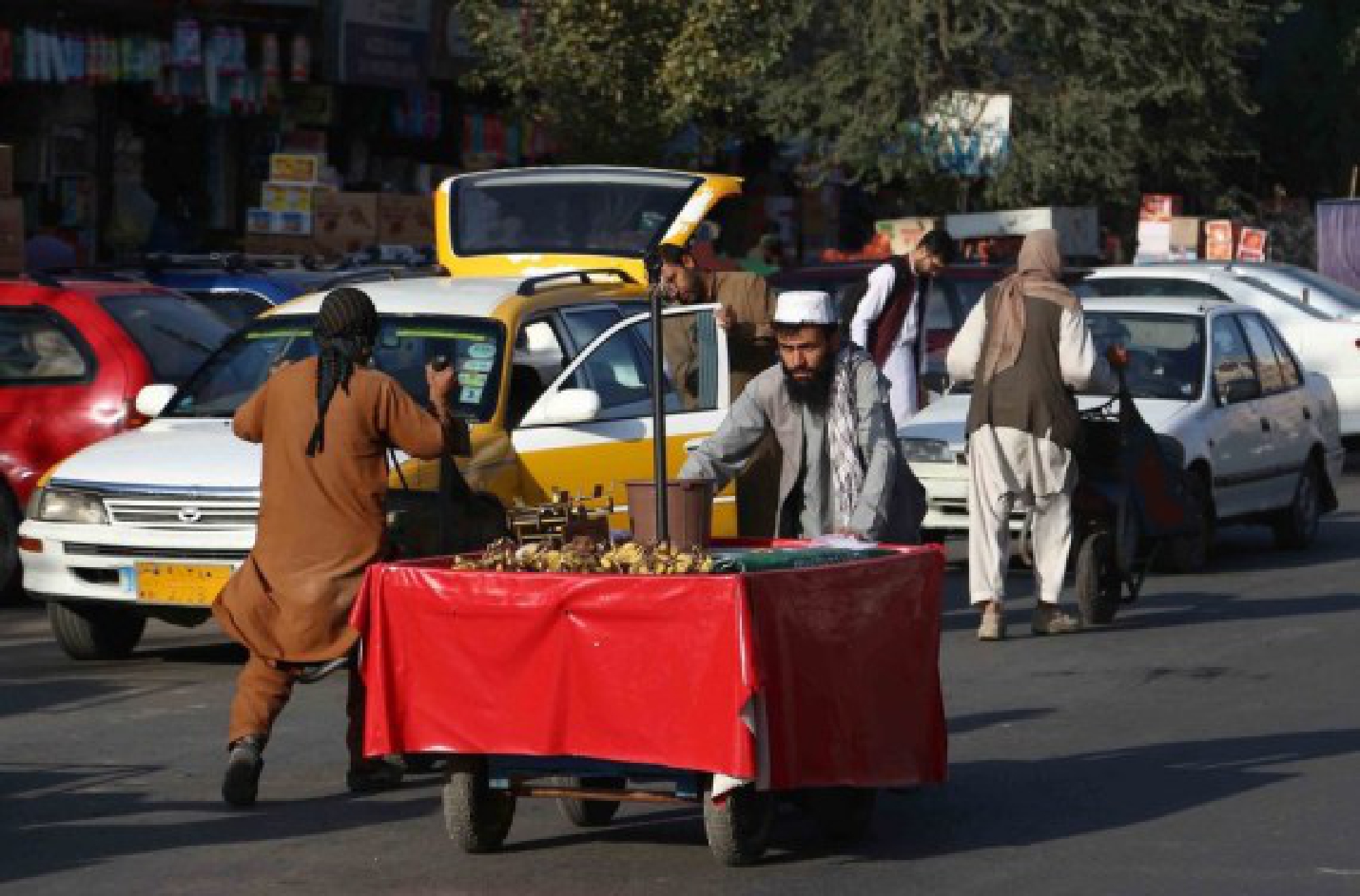 Vendors push their handcarts on a street in Kabul, capital of Afghanistan, Sept. 15, 2021. (Photo by Kabir/Xinhua)