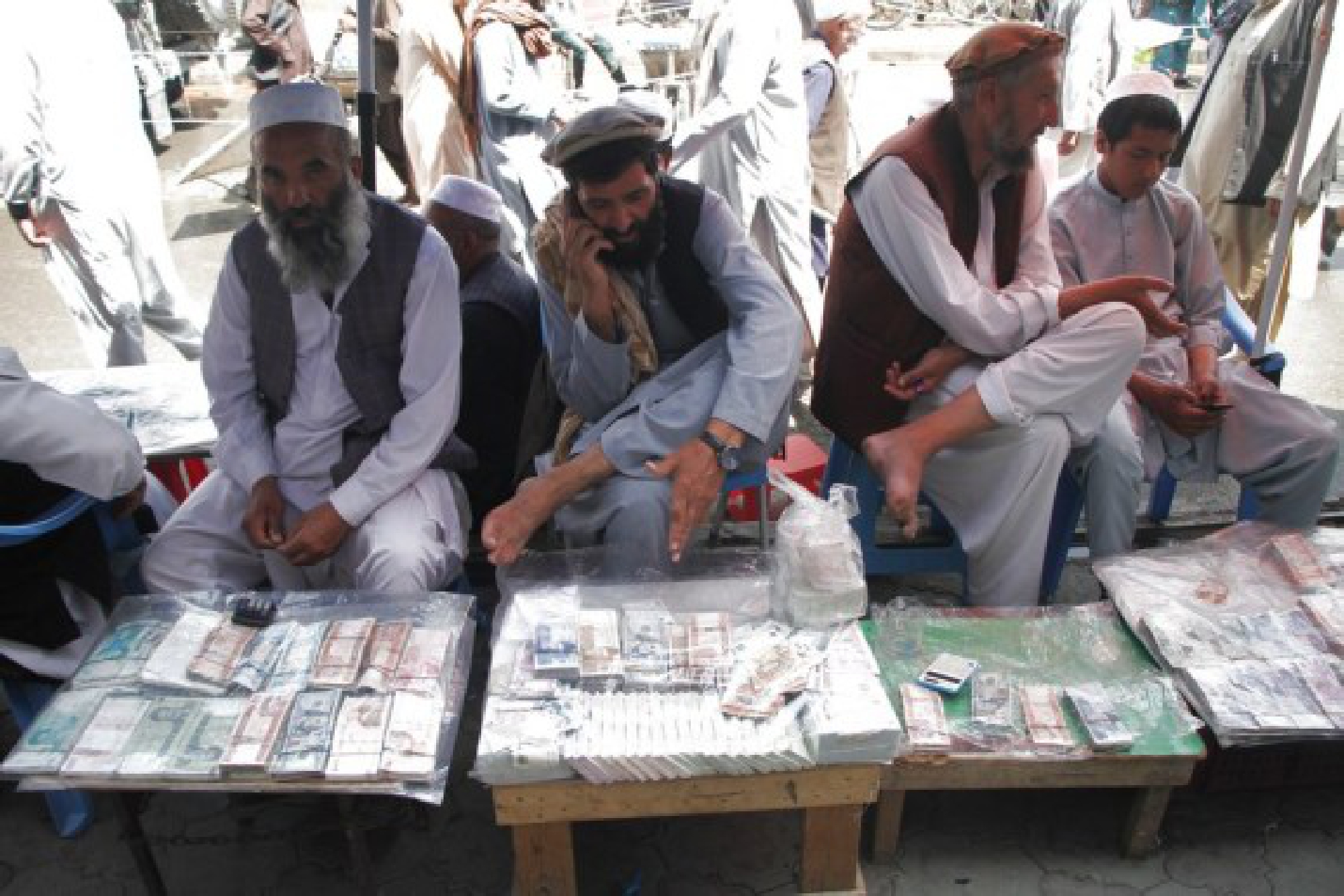 Afghan currency exchange dealers wait for customers in Kabul, capital of Afghanistan, Sept. 4, 2021. 