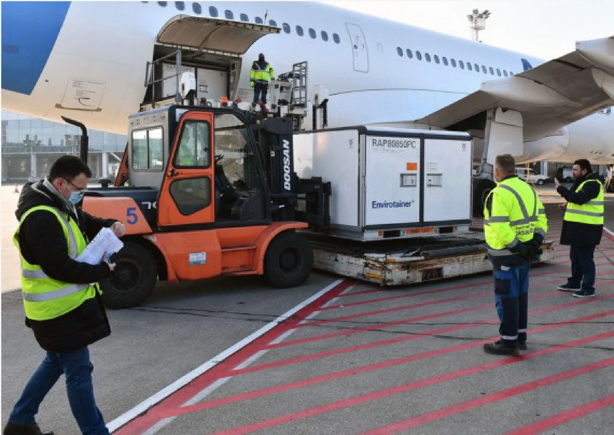  Workers unload a container of China's Sinopharm inactivated coronavirus vaccines at the Belgrade Airport, Serbia, Jan. 16, 2021.