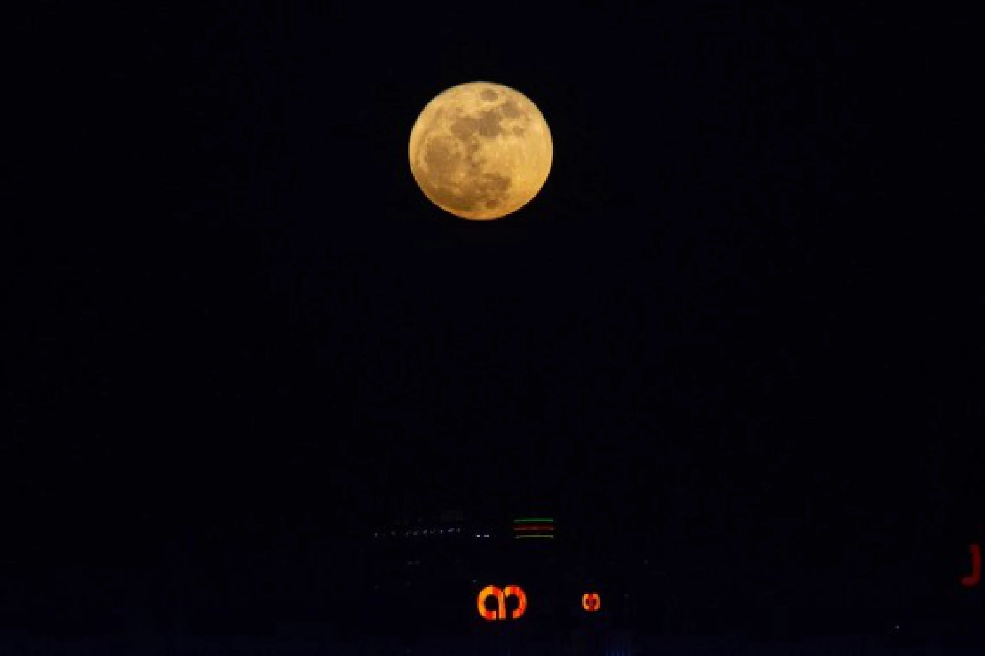 A full moon is seen against the skyline of Kuala Lumpur, Malaysia, on the occasion of Mid-Autumn Festival on Sept. 21, 2021. (Photo by Chong Voon Chung/Xinhua)