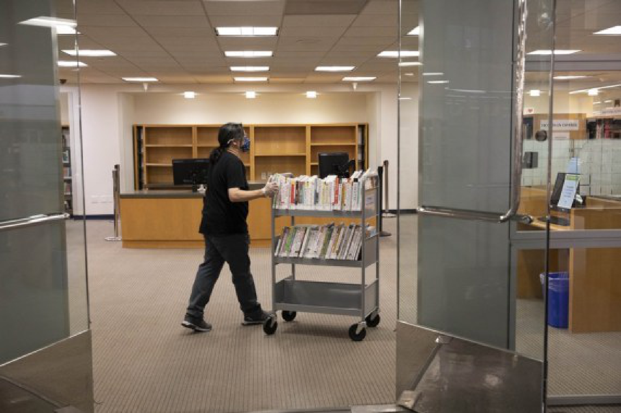 A staff member works at the San Francisco Public Library in San Francisco, the United States, May 3, 2021. (Photo by Li Jianguo/Xinhua)