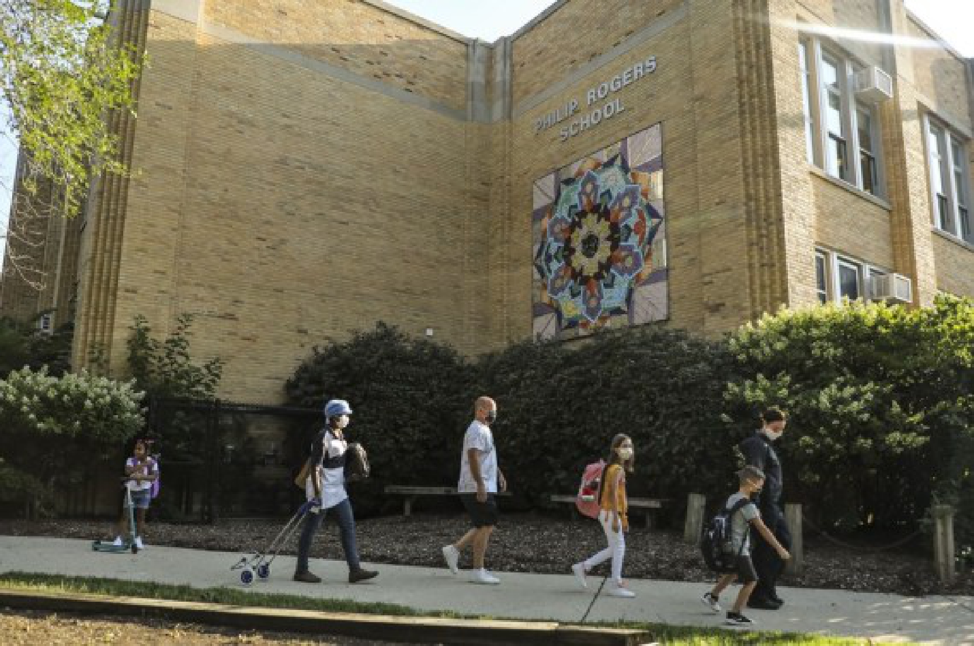 Students arrive for the first day of full attendance at Phillip Rogers Elementary School in Chicago, on Aug. 30, 2021. 