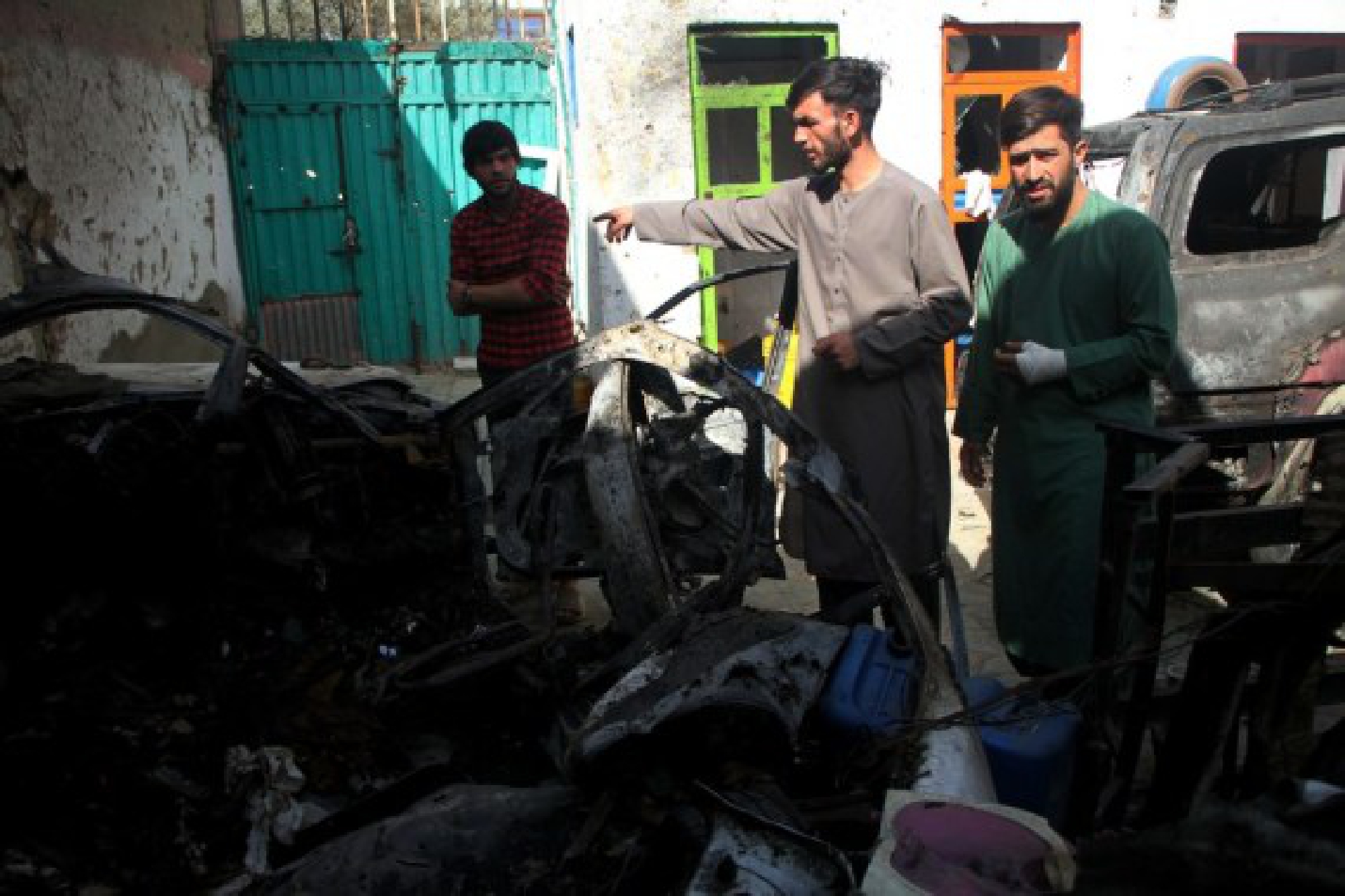 People stand at the site of the U.S. airstrike in Kabul, capital of Afghanistan, Sept. 2, 2021. 
