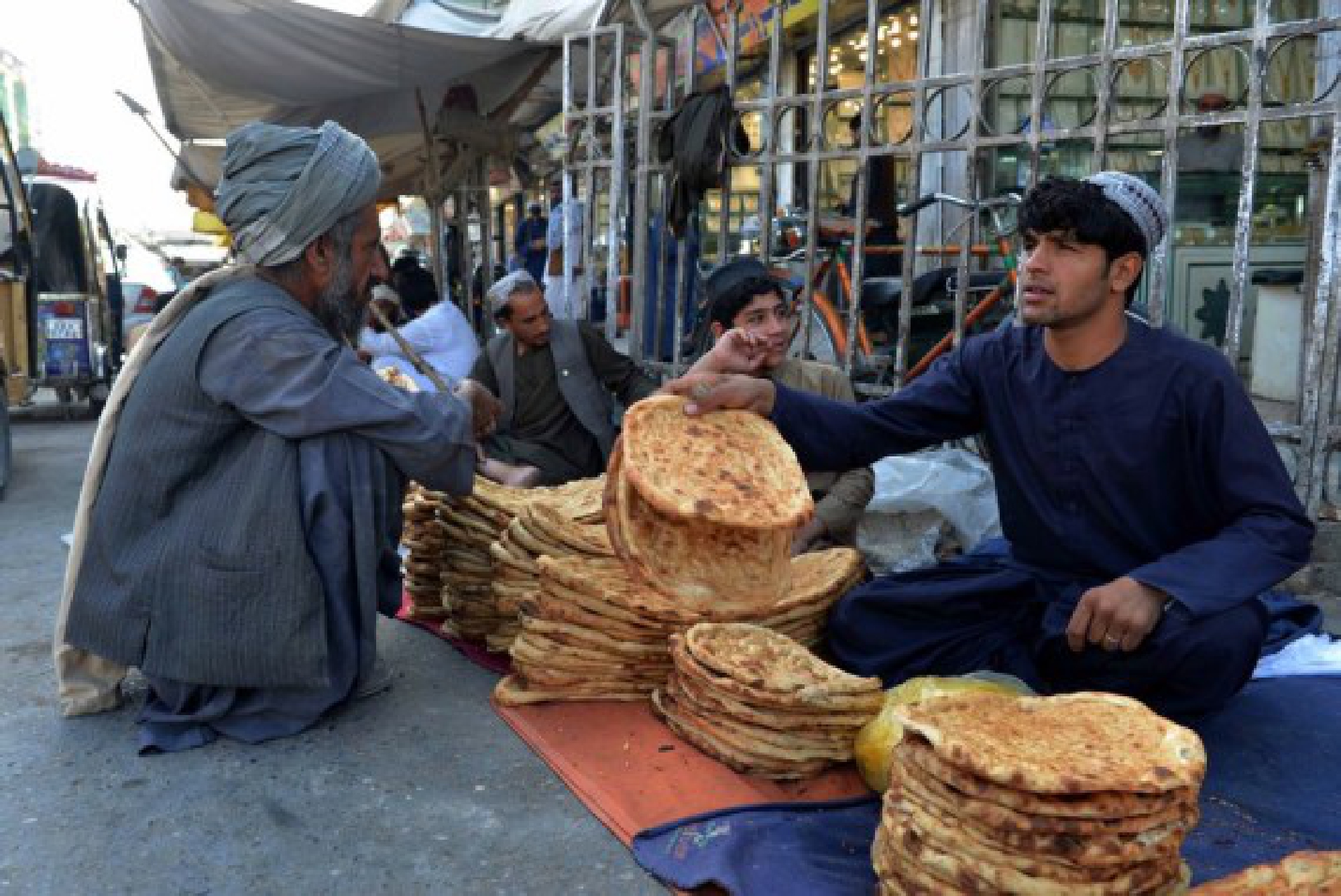 An Afghan vendor sells food for consumers in Kandahar city, southern Afghanistan, Sept. 14, 2021. (Photo by Sanaullah Seiam/Xinhua)
