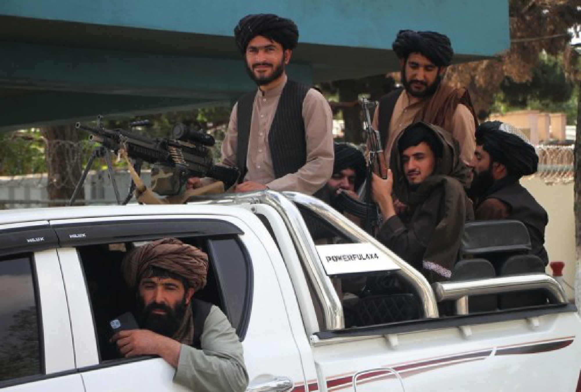 Taliban members are seen on a military vehicle at Kabul airport in Kabul, capital of Afghanistan, Aug. 31, 2021. (Photo by Saifurahman Safi/Xinhua)