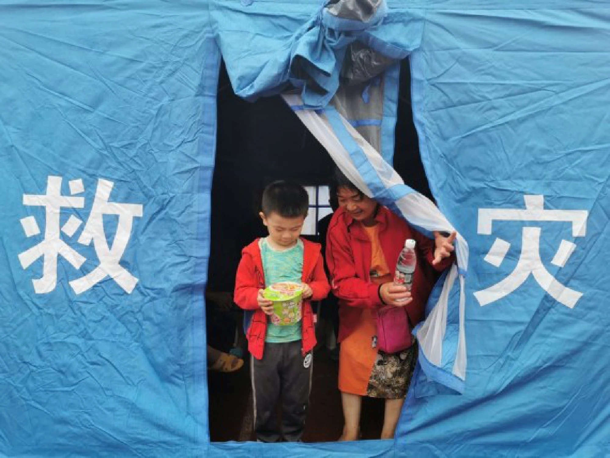 Evacuated people are seen at a temporary relocation site after an earthquake in Jiaming Township of Luxian County, southwest China's Sichuan Province, Sept. 16, 2021. (Photo by Liu Xueyi/Xinhua)