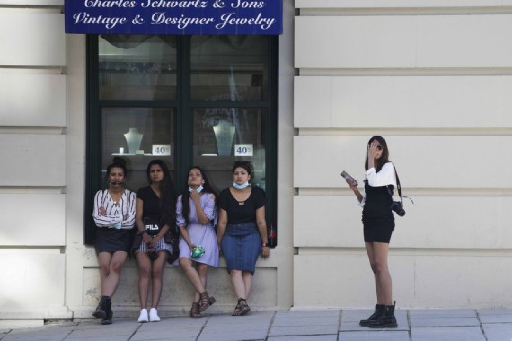 Pedestrians rest by a jewelry store in Washington, D.C., the United States, June 17, 2021.