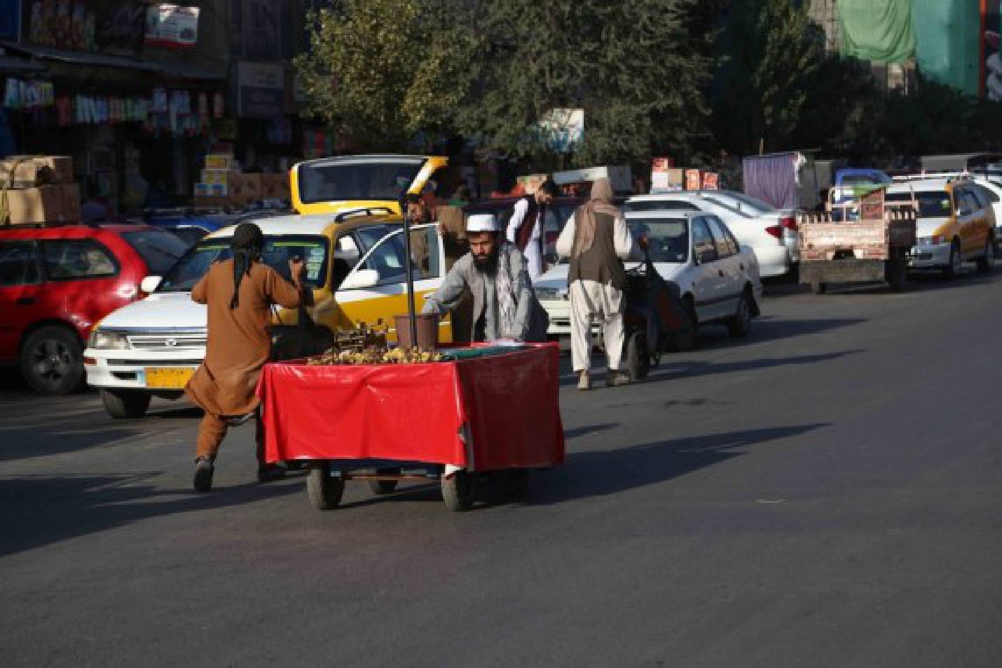 Afghans push their handcarts on a street in Kabul, capital of Afghanistan, Sept.15, 2021. 