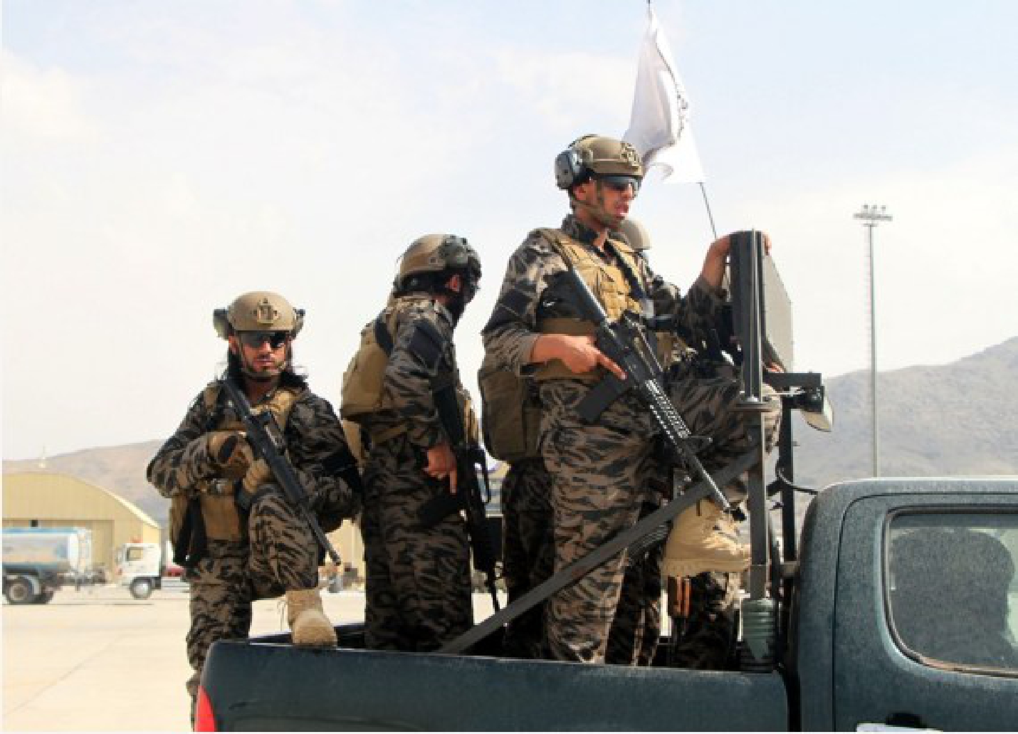Taliban members are seen on a military vehicle at Kabul airport in Kabul, capital of Afghanistan, Aug. 31, 2021. 