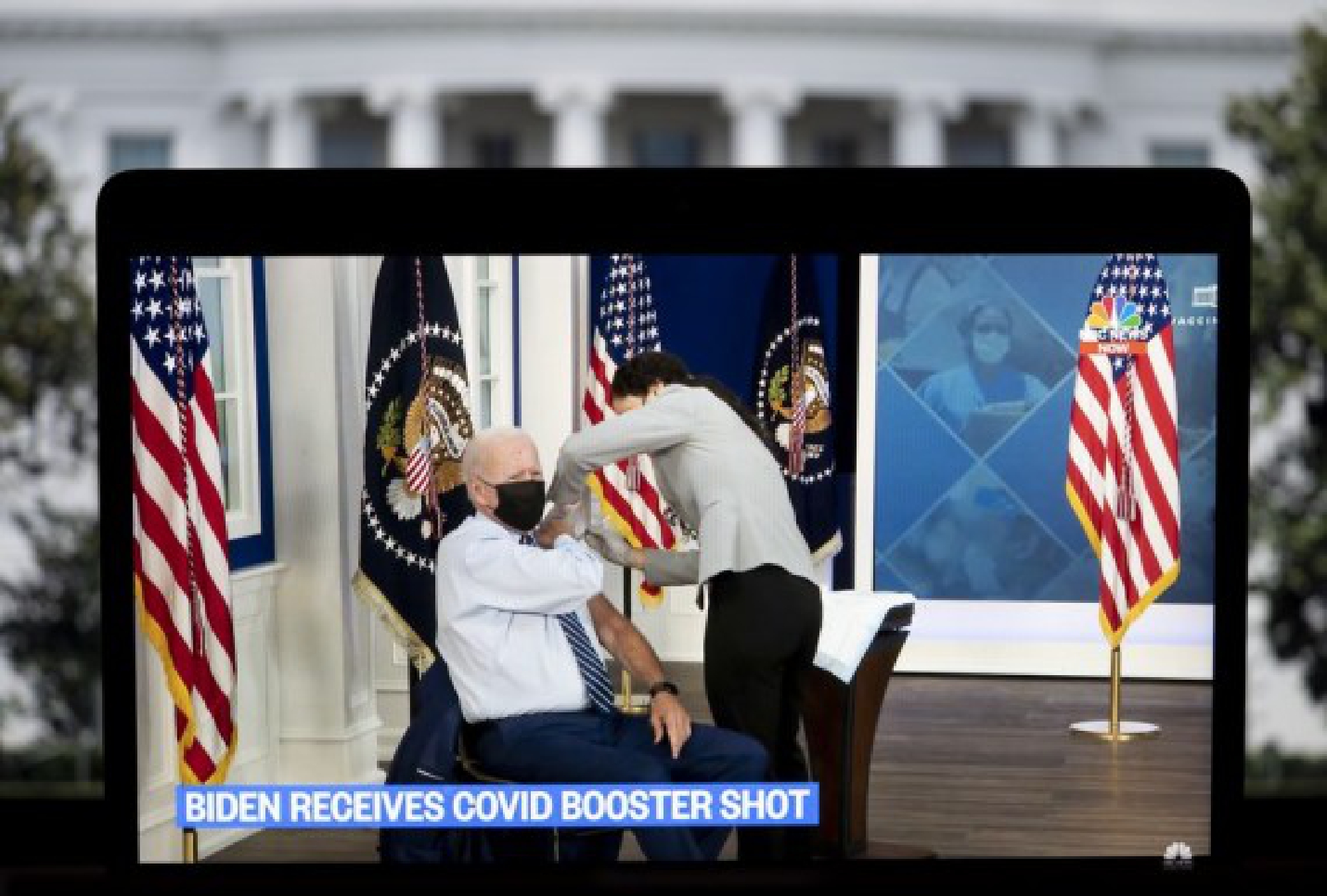 U.S. President Joe Biden is seen on a screen as he receives his COVID-19 vaccine booster shot in Washington, D.C., the United States, on Sept. 27, 2021. (Xinhua/Liu Jie)