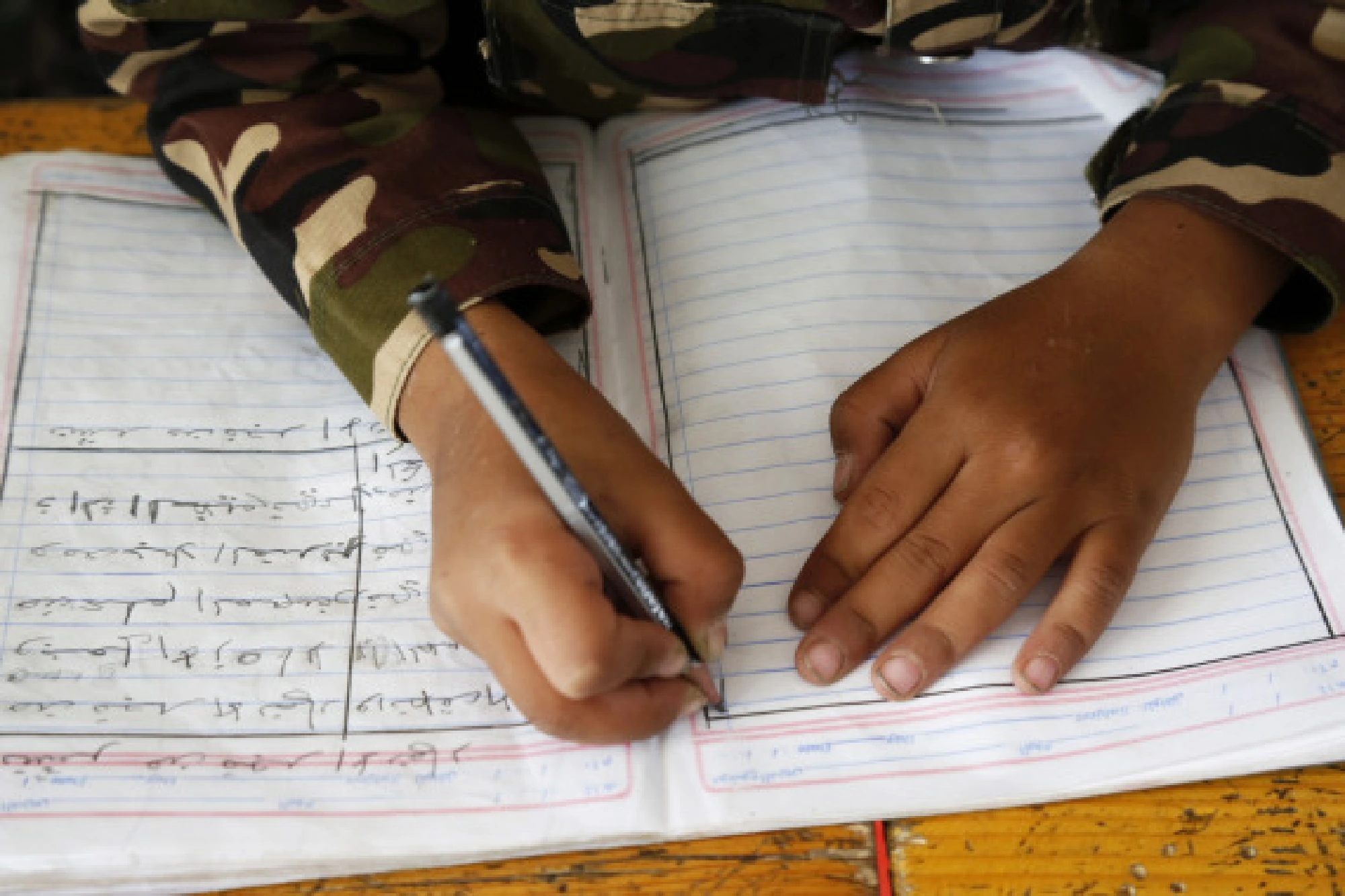 A child takes note during a class at a school in Sanaa, Yemen, on Sept. 8, 2021. 