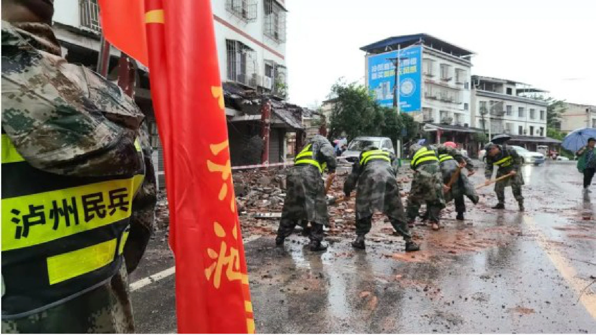 Photo taken with a mobile phone shows rescuers removing debris on a street in Fuji Town of Luxian County, southwest China's Sichuan Province, Sept. 16, 2021. (Xinhua)