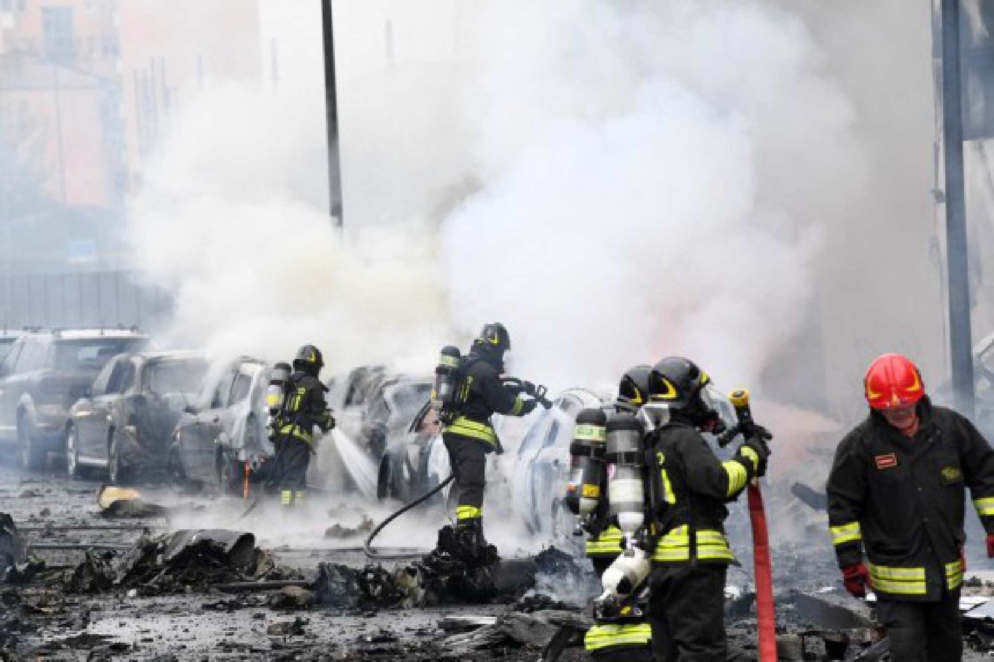 Firefighters work on the site of a plane crash in Milan, Italy, Oct. 3, 2021. (Str/Xinhua)