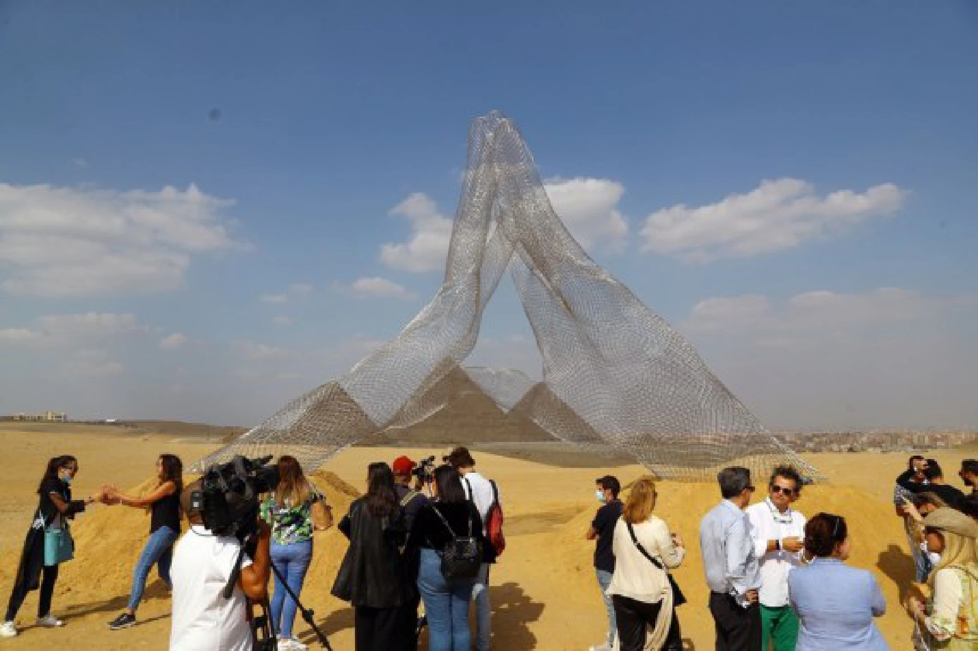 Visitors gather in front of Italian artist Lorenzo Quinn's sculpture &quot;Together&quot; during an international art exhibition in Giza, Egypt, on Oct. 21, 2021. (Xinhua/Ahmed Gomaa)
