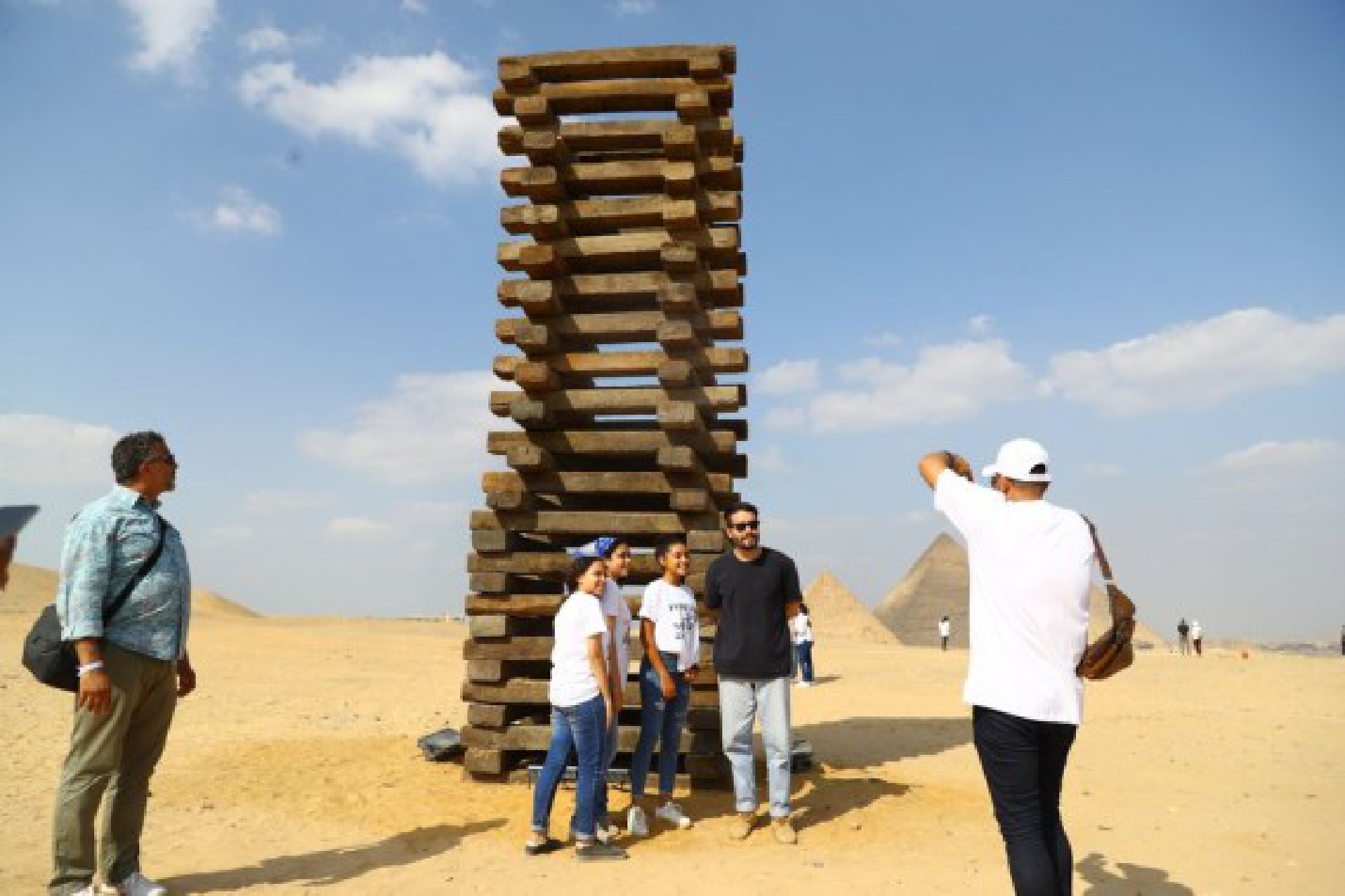 Visitors pose for photos with an artwork during an international art exhibition in Giza, Egypt, on Oct. 21, 2021. (Xinhua/Ahmed Gomaa)