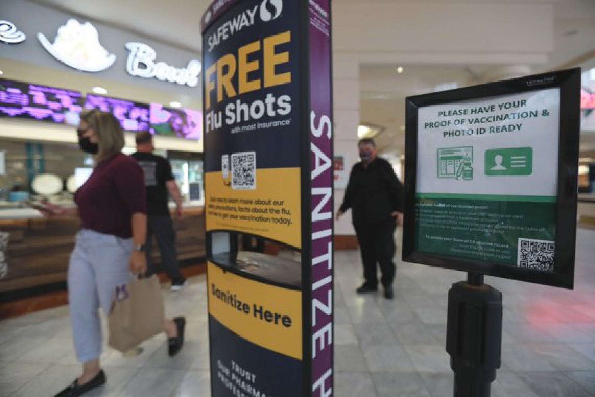 A placard reminding people of having proof of vaccination and photo ID ready is seen in San Francisco, the United States, Aug. 20, 2021. (Photo by Liu Yilin/Xinhua)