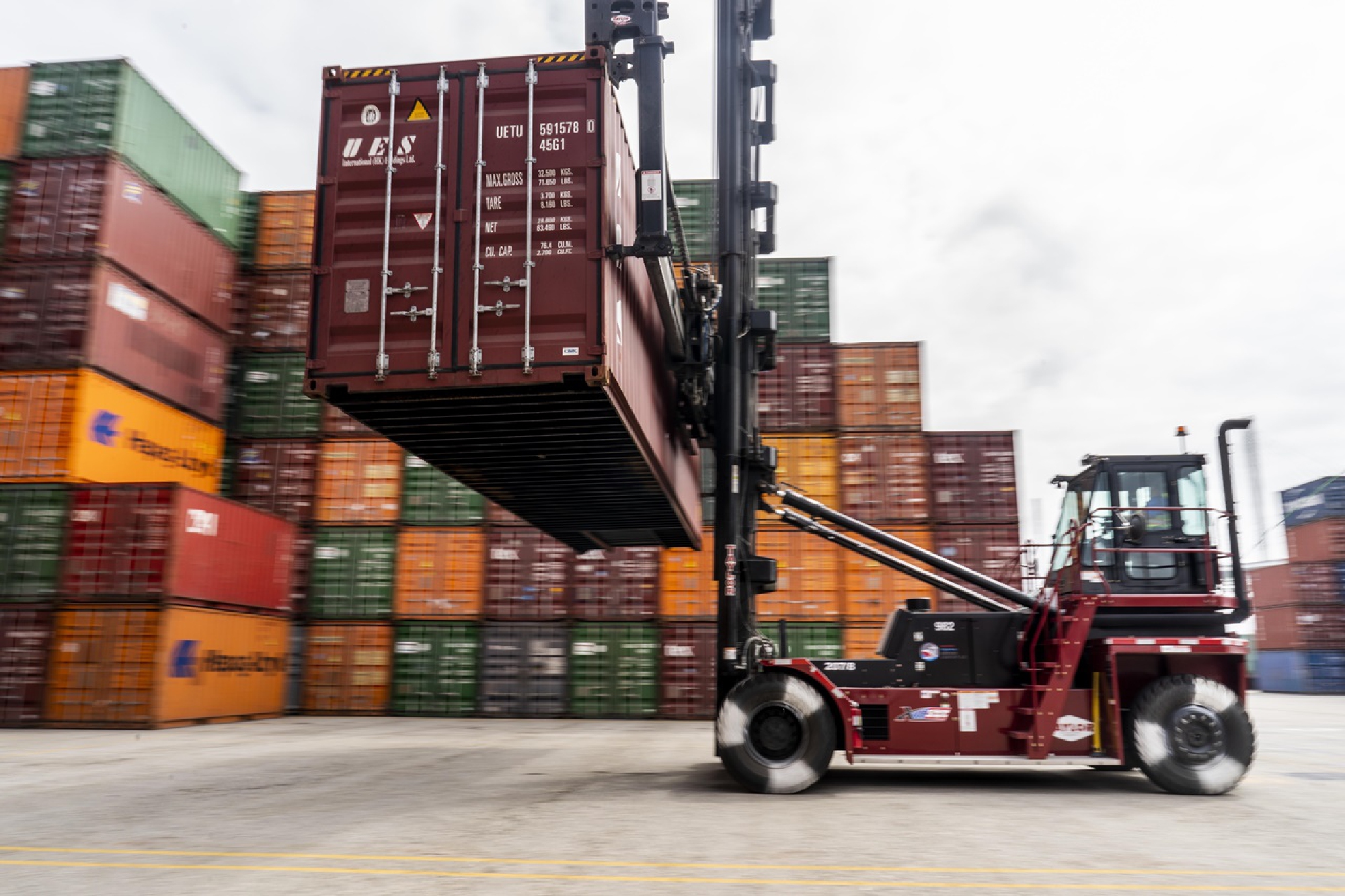 Containers are moved around at the Port of Los Angeles recently. PHOTO CREDIT: Washington Post photo by Melina Mara